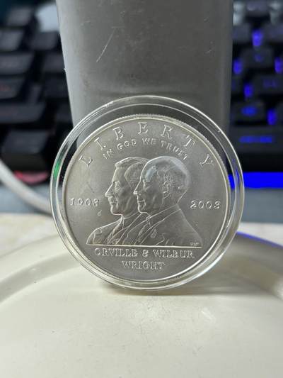 第185期拍卖 - 美国2003年人类首飞莱特兄弟磨砂版银币，900银，26.72克，银价359.5