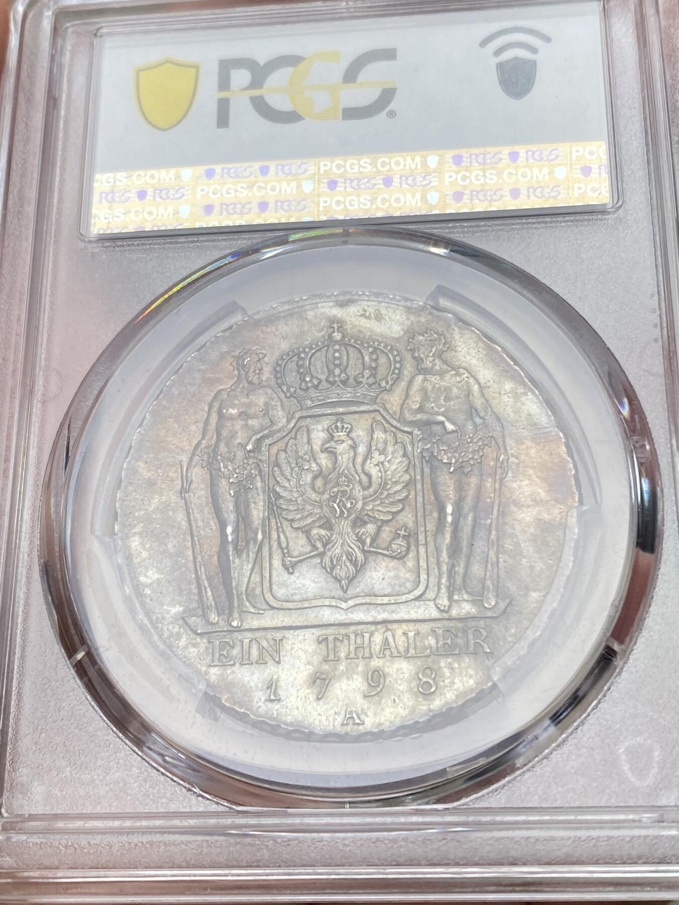 万国钱币拍卖第058期（万国新年大拍） PCGS MS64 1798年德国普鲁士威廉三世野人护盾流通大泰勒 普鲁士名品之一 均匀德式五彩 打制周正  威三胸前勋章以及野人重点部位的高点极其出色 一步到位的典藏级品质 PCGS冠军分