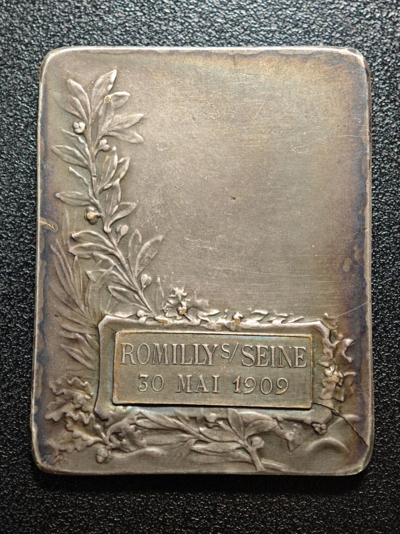 【德藏】世界币章拍卖第158期（拍品征集中~欢迎藏友联系） 1909年 法国塞纳河畔罗米利音乐主题矩形镀银纪念章 由法国新艺术时期铸章师设计打造，是为当地音乐活动颁发的荣誉表彰牌 塞纳河畔罗米利（Romilly-sur-Seine）是法国香槟-阿登地区的城市，1909年当地举办音乐赛事或庆典活动，此纪念牌作为荣誉奖品颁发给优秀的音乐从业者/参赛者，是法国地方文化艺术活动的实物见证 深五彩包浆 直径约：39.4mm×50mm；重约：44.1g