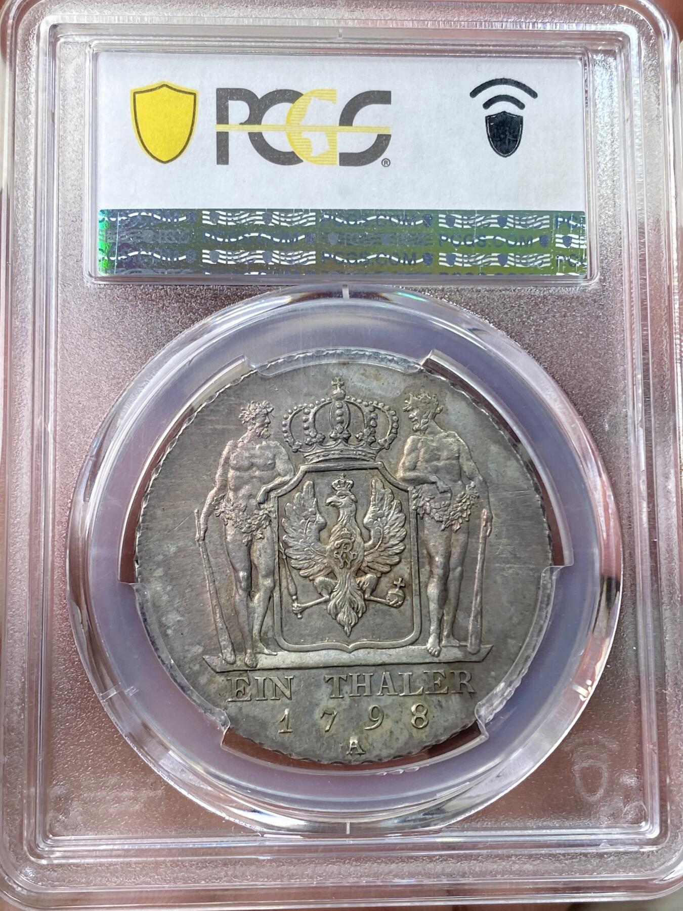 万国钱币拍卖第058期（万国新年大拍） PCGS MS64 1798年德国普鲁士威廉三世野人护盾流通大泰勒 普鲁士名品之一 均匀德式五彩 打制周正  威三胸前勋章以及野人重点部位的高点极其出色 一步到位的典藏级品质 PCGS冠军分