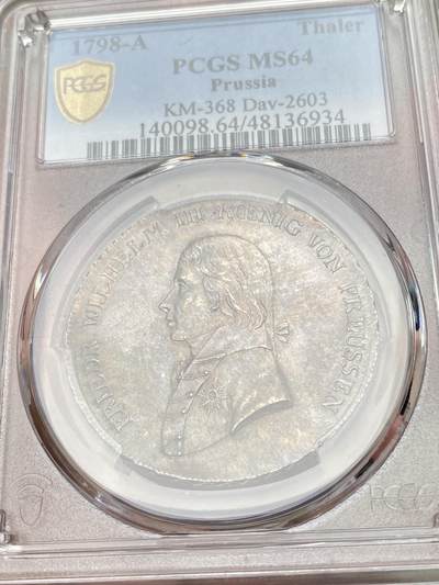 万国钱币拍卖第058期（万国新年大拍） PCGS MS64 1798年德国普鲁士威廉三世野人护盾流通大泰勒 普鲁士名品之一 均匀德式五彩 打制周正  威三胸前勋章以及野人重点部位的高点极其出色 一步到位的典藏级品质 PCGS冠军分