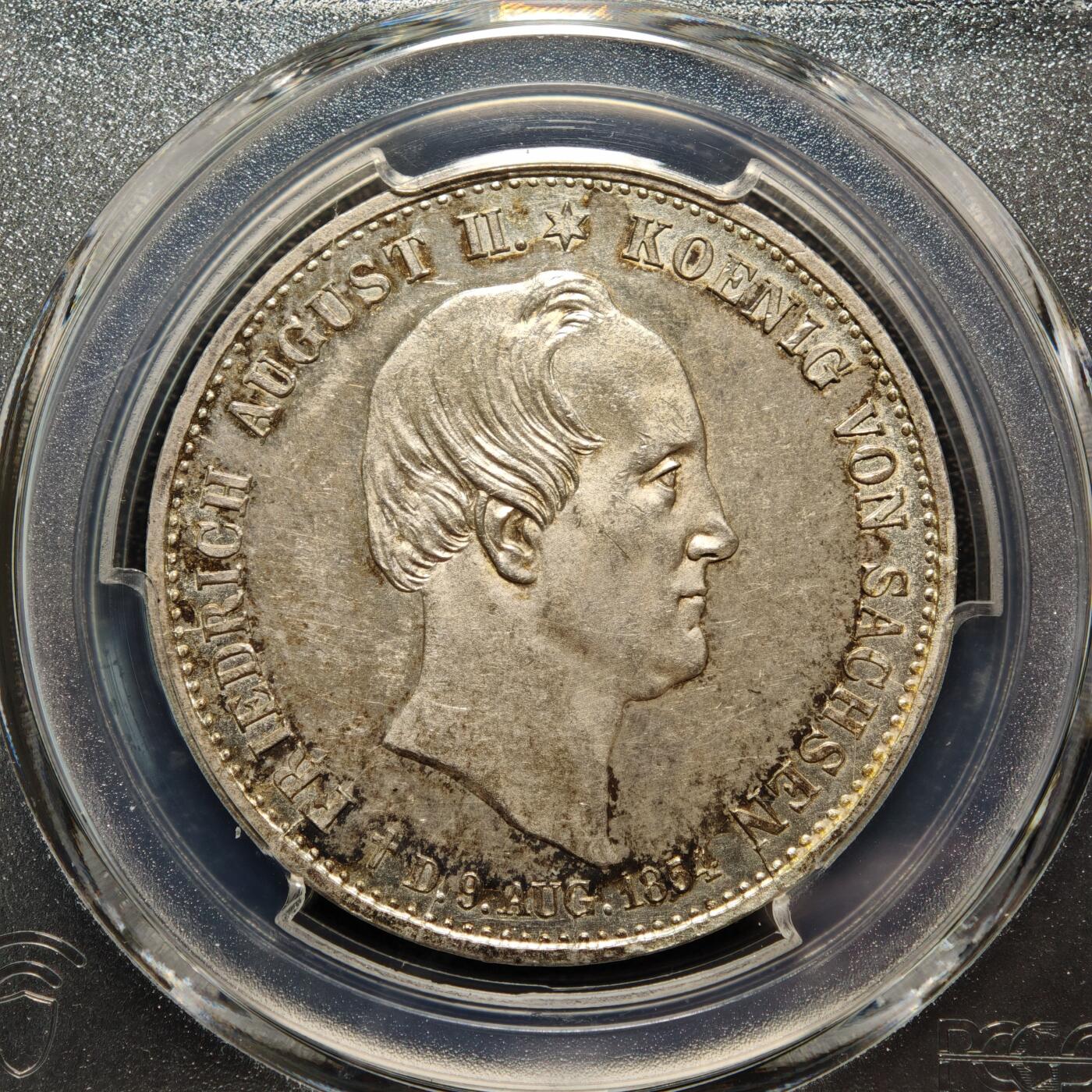 【德藏】世界币章拍卖第158期（拍品征集中~欢迎藏友联系） 1854年 德国萨克森弗里德里希·奥古斯特二世银婚纪念泰勒银币 PCGS MS62 少见品种 原味包浆 状态十足 1854年是弗里德里希·奥古斯特二世与奥地利的玛丽亚·安娜公主结婚25周年（银婚），作为萨克森王国的重要王室庆典，发行此币以纪念这一事件，同时彰显王室联姻的政治与家族意义