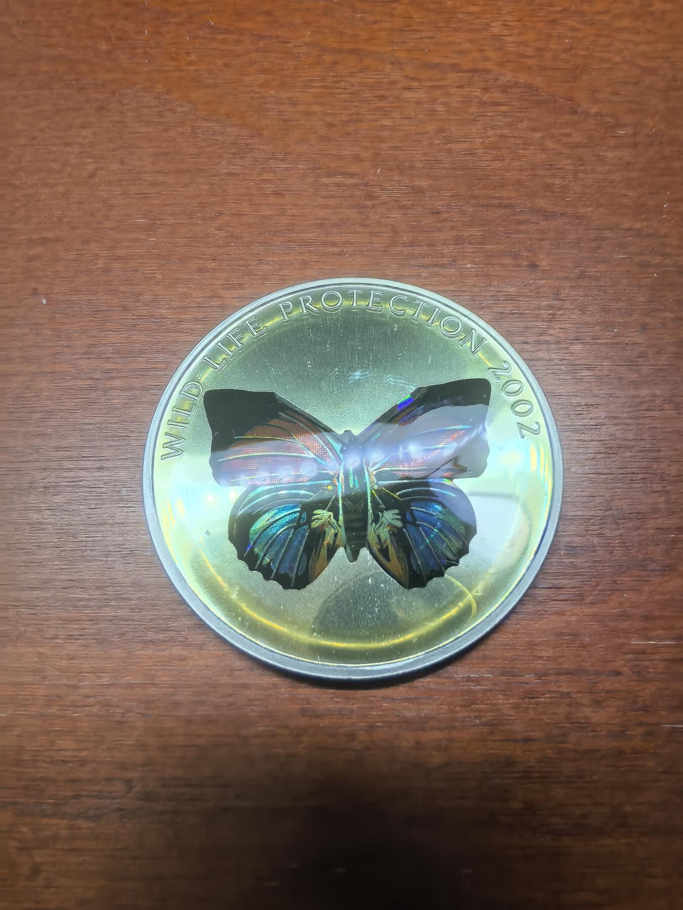 长老汇蛇年精选第八十七场拍卖 2002刚果非洲珍稀蝴蝶之多彩黑蝴蝶10法郎全息幻彩精制银币，25.95克925银，1.5万枚，克书65美金
