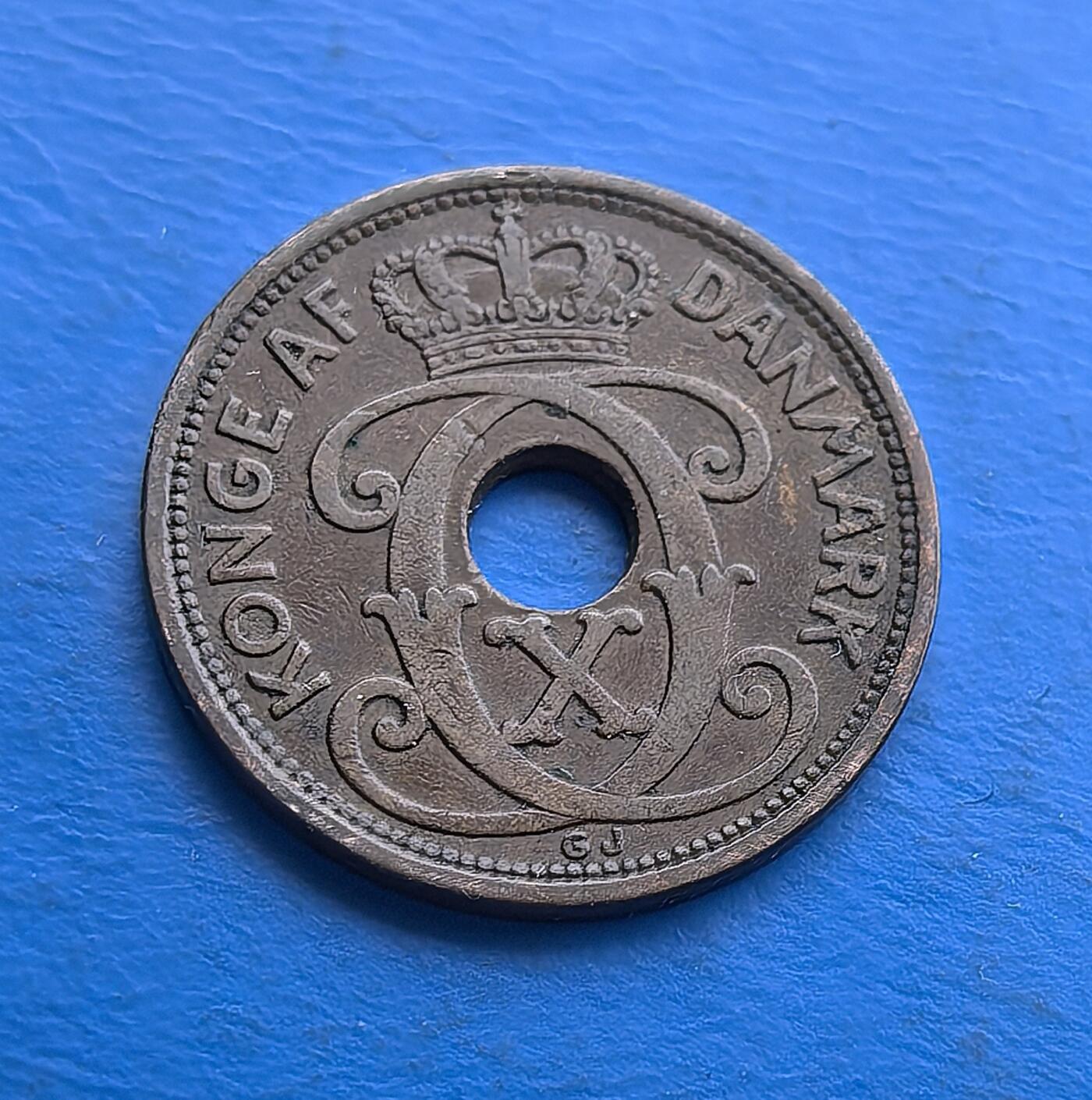 外国优质老铜币高银银币，周六九点倒数截拍，满百包邮，持续收拍 丹麦1927 年2 欧尔青铜圆孔币，发行于克里斯蒂安十世统治期（二战前和平阶段）。正面饰王室花押与皇冠，背面镌 “DANMARK”、年份及面值，圆孔设计独特。青铜包浆厚重，见证战前丹麦货币工艺，是北欧君主制钱币收藏的经典标的，承载早期王室货币的历史韵味 。