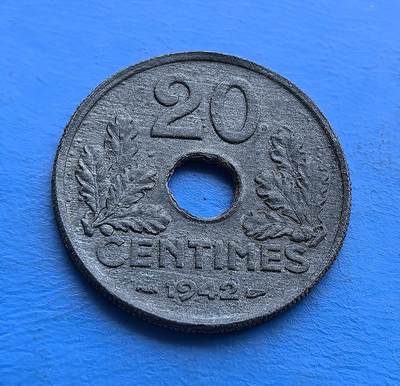 外国优质老铜币高银银币，周六九点倒数截拍，满百包邮，持续收拍 - 维希法国1942 年 20 生丁圆孔币，铸于二战沦陷期。正面 “ETAT FRANCAIS” 彰显政权符号，背面橡叶环护面额，圆孔设计因物资匮乏而生。劣质材质凝岁月痕，承载战时经济困局与维希时代印记，是二战被占区货币的微观标本，亲民门槛解码法国黑暗岁月的货币脉络 。