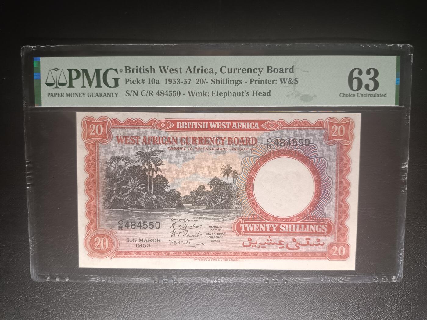 2025十二月第五期，总210期 英属西非1953年20先令PMG63分，稀有中高面值，经典的雨林河流和可可果采摘场景