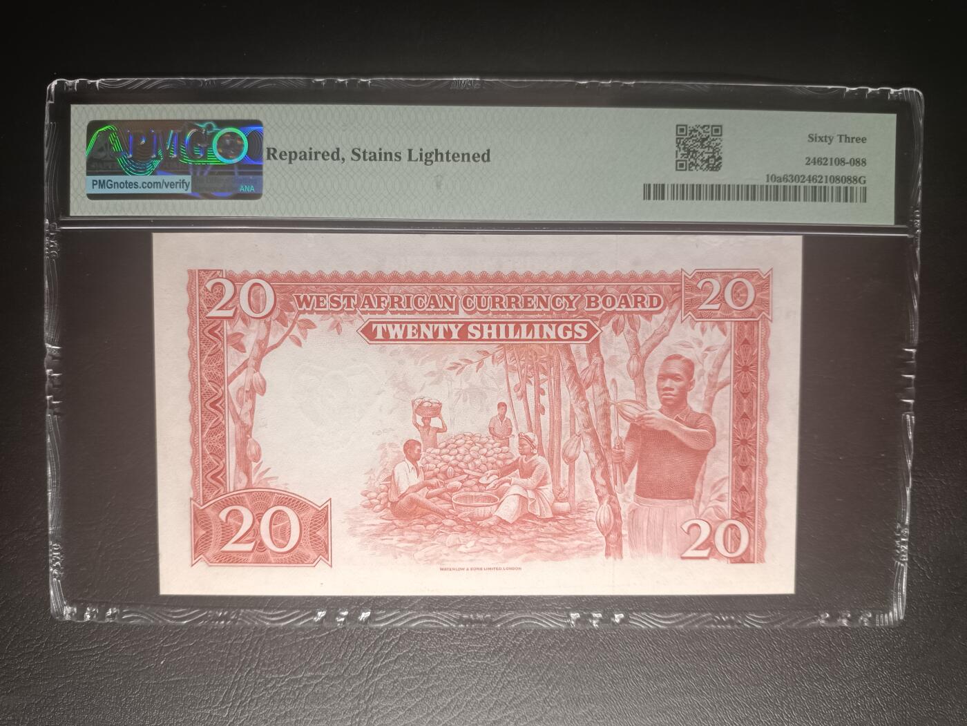 2025十二月第五期，总210期 英属西非1953年20先令PMG63分，稀有中高面值，经典的雨林河流和可可果采摘场景