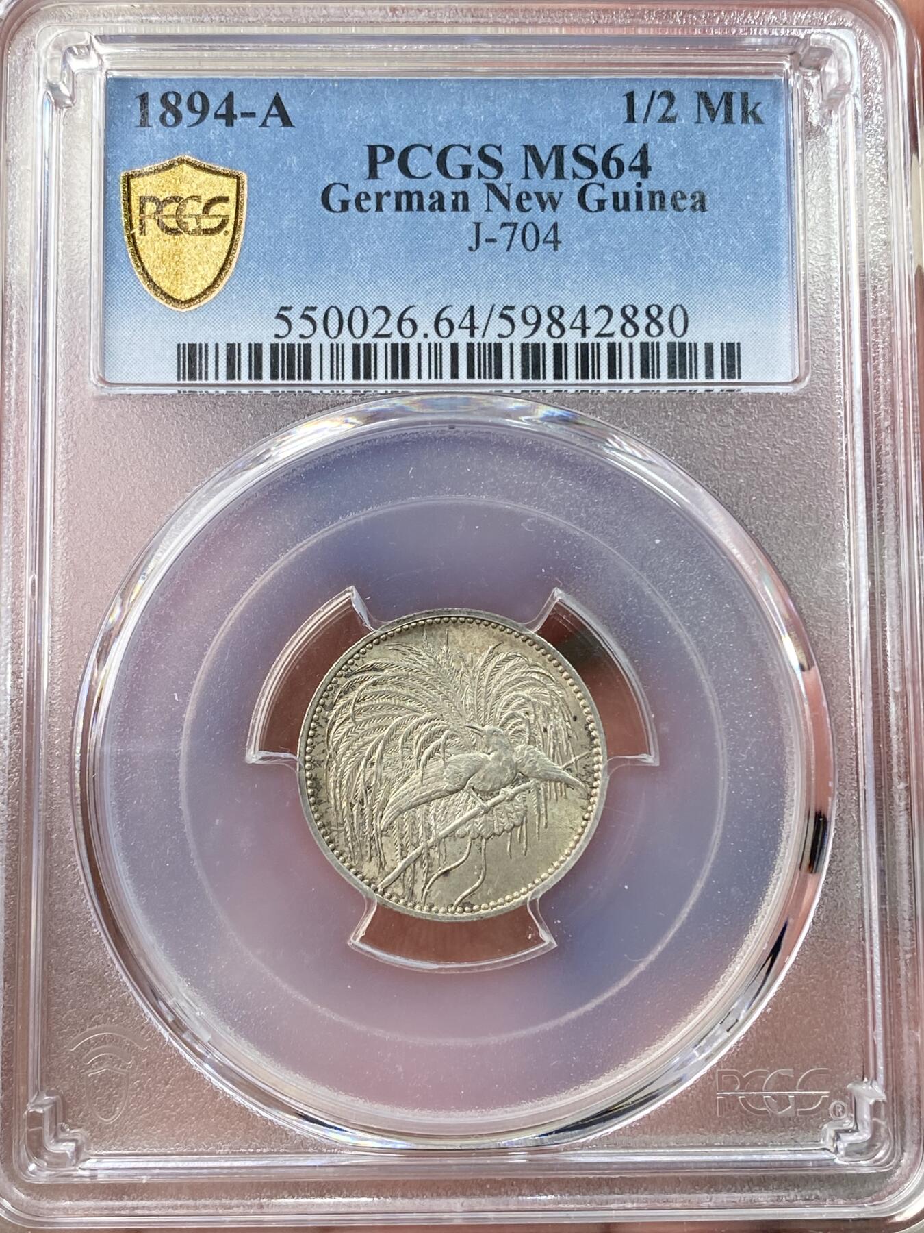 万国钱币拍卖第058期（万国新年大拍） PCGS MS64 1894德属新几内亚天堂鸟1/2马克银币 德属大名誉品种 炫技式的华丽天堂鸟雕刻 原味包浆黄油转光 顶级收藏品质