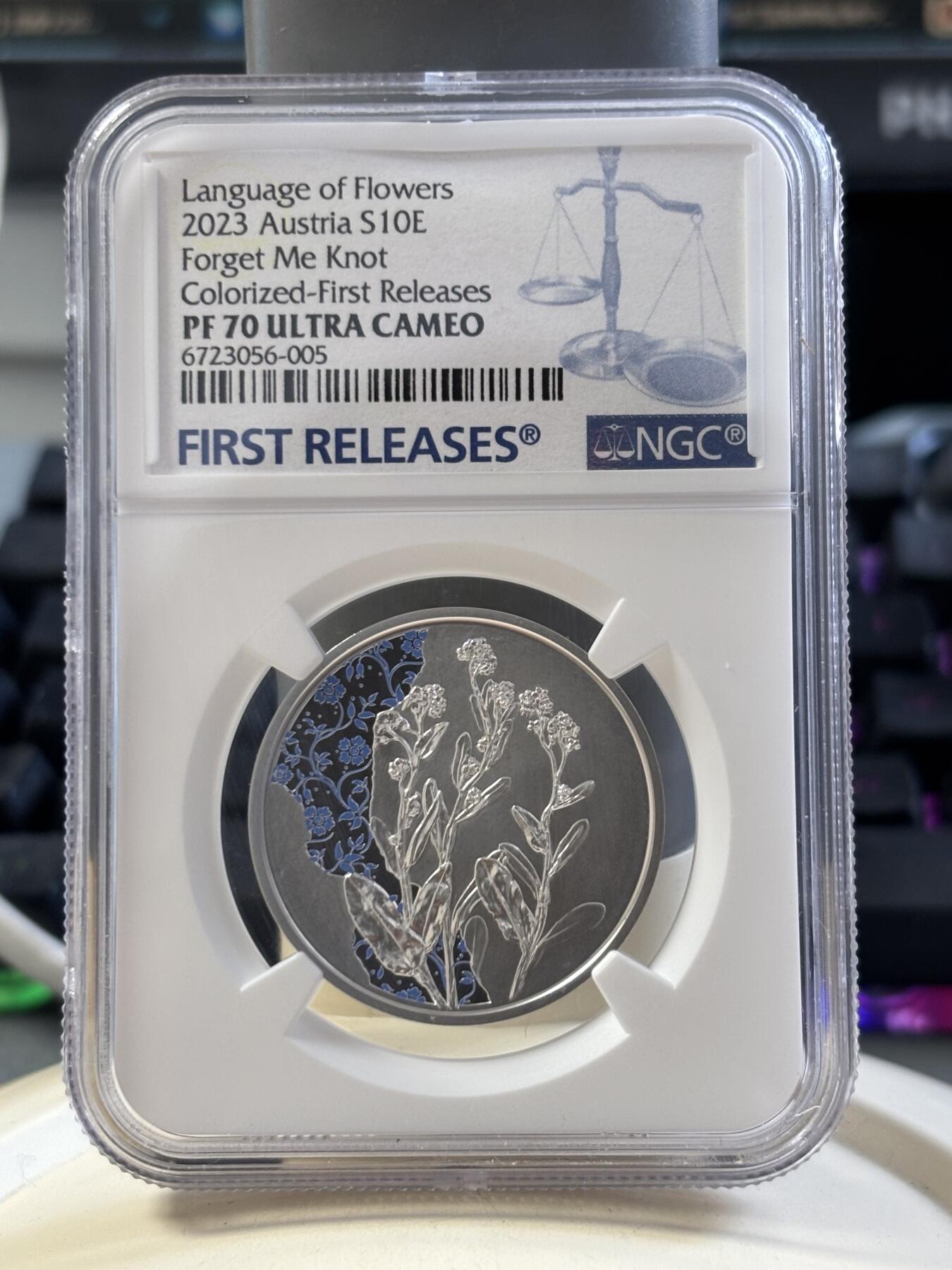第186期拍卖 盒证齐全奥地利2023年花语系列勿忘我NGC评级首期蓝标70分彩色精制纪念银币
