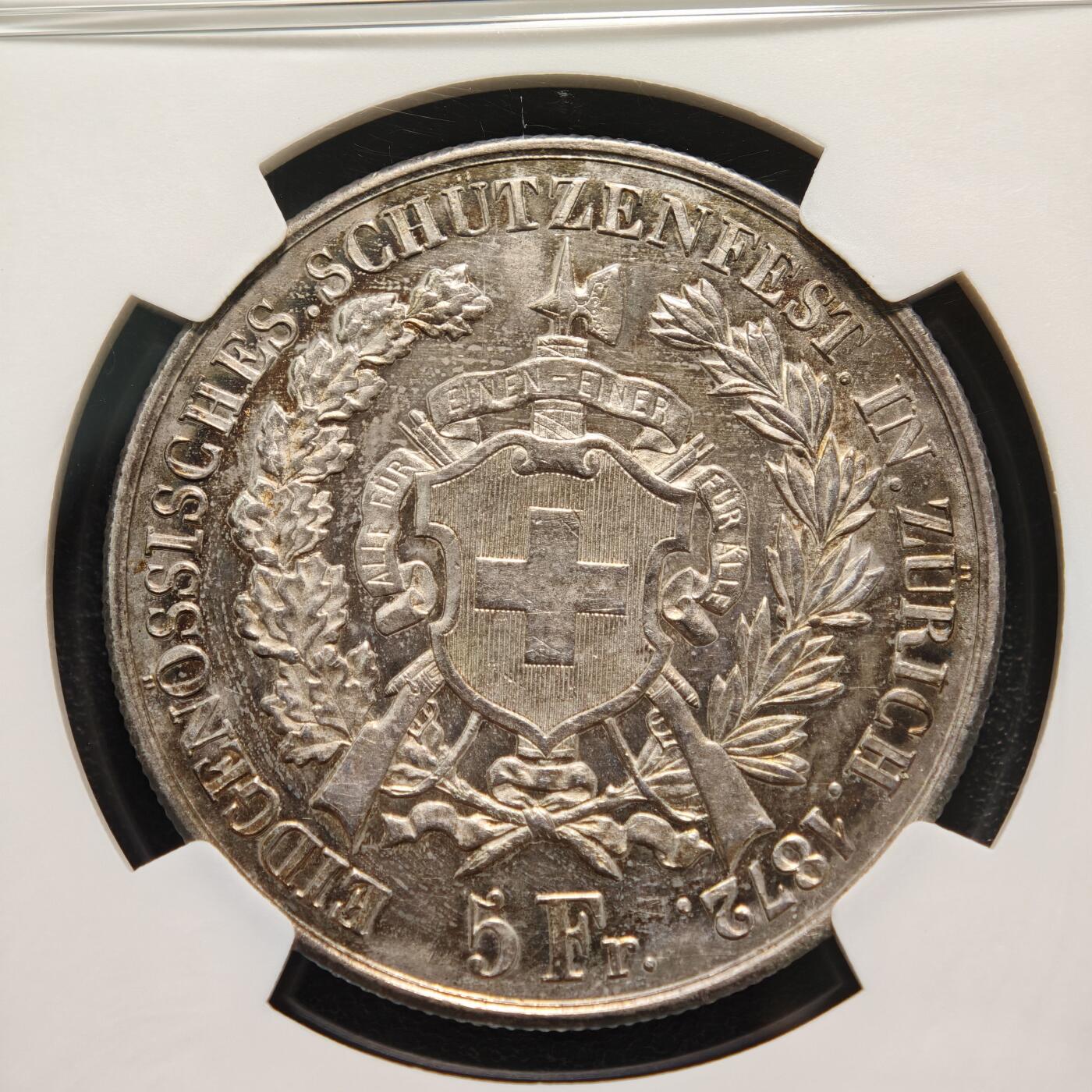 【德藏】世界币章拍卖第159期(元旦专场拍卖) 1872年 瑞士苏黎世射击节5法郎大银币，发行量仅1万枚 NGC MS61 正面是瑞士自由女神一手高举桂冠、一手扶着盾牌的站立像，背面是瑞士盾牌和射击节徽章，雕刻精美，保存状态良好，五彩包浆，稀少品种，NGC低评