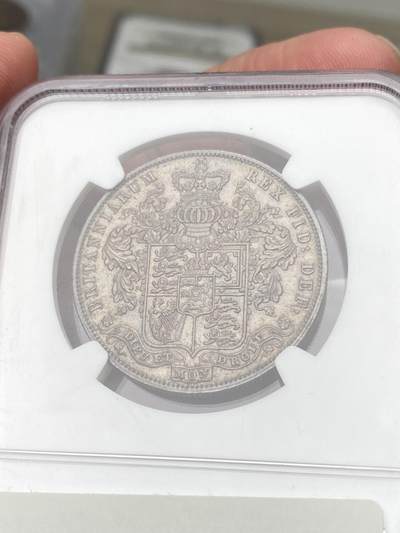 万国钱币拍卖第058期（万国新年大拍） NGC MS64 1825年英国乔治四世半克朗银币 与1826精制克朗相同的设计 依旧华丽的摄政风格 64级别已是相当难得的存在 丝绸般的底板在紫罗兰渐变五彩的加持下令人赏心悦目 不容错过的顶级收藏品质