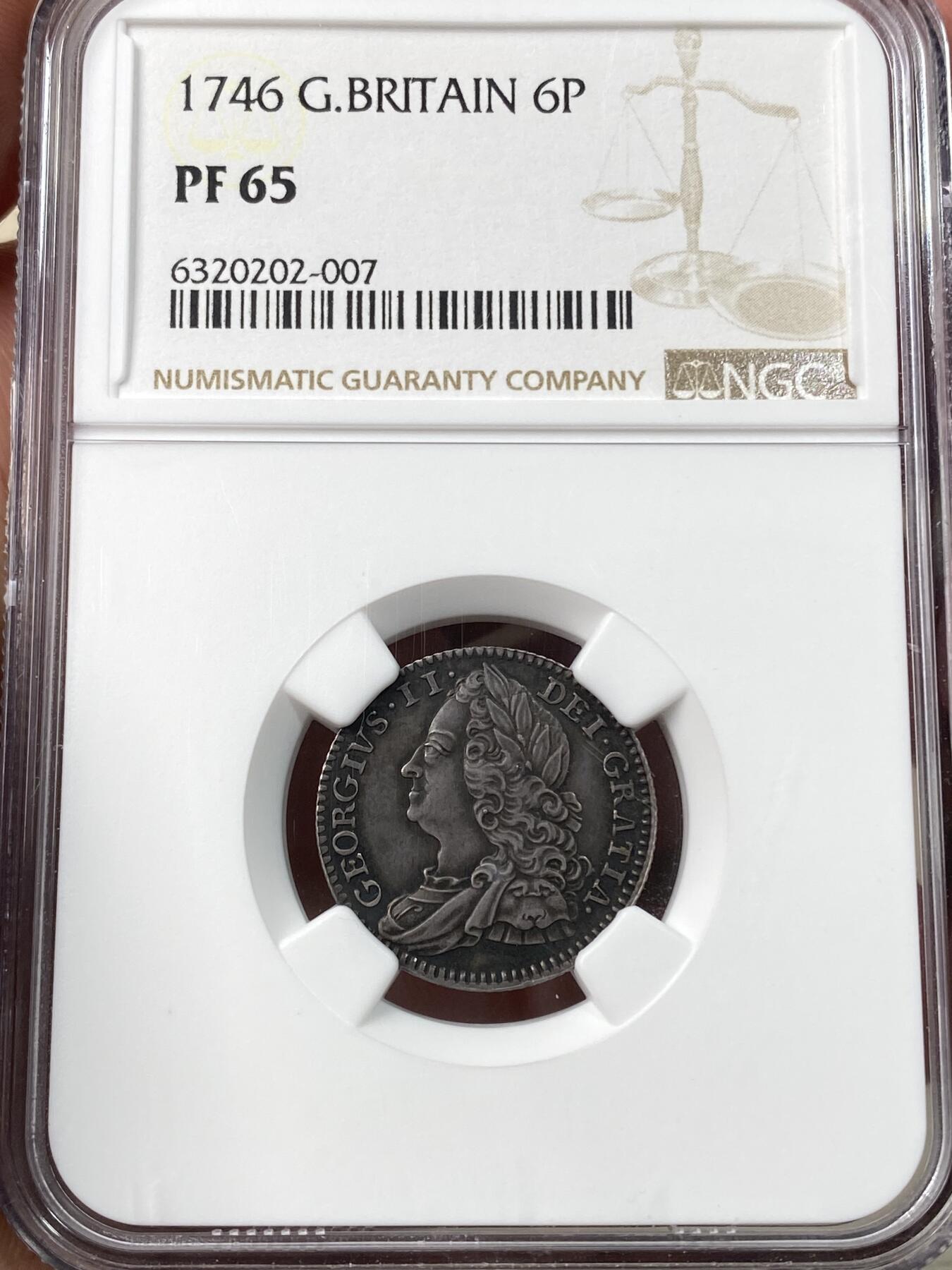 万国钱币拍卖第058期（万国新年大拍） NGC PF65 1746年英国乔治二世精制6便士银币 出自英国历史上第一次公开发行的精制套币 发行量仅有令人咋舌的100套 与普制完全不同的工艺与观感 均匀英式乌云包浆 附带6枚出售及拍卖标签 流传有序