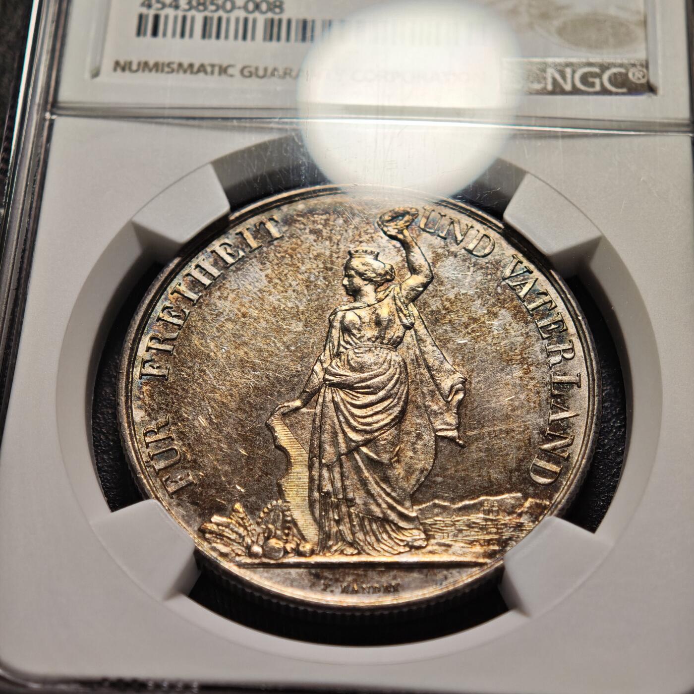 【德藏】世界币章拍卖第159期(元旦专场拍卖) 1872年 瑞士苏黎世射击节5法郎大银币，发行量仅1万枚 NGC MS61 正面是瑞士自由女神一手高举桂冠、一手扶着盾牌的站立像，背面是瑞士盾牌和射击节徽章，雕刻精美，保存状态良好，五彩包浆，稀少品种，NGC低评