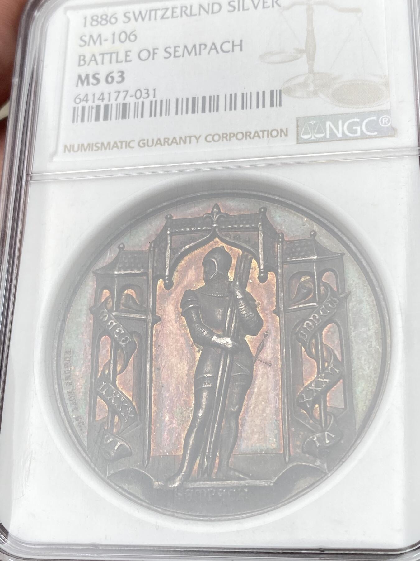 万国钱币拍卖第058期（万国新年大拍） NGC MS63 1886年瑞士萨姆帕奇战役纪念大银章 原味五彩高浮雕 NGC加厚盒 火烧云般的醇厚紫红葡萄酒包浆极其诱人