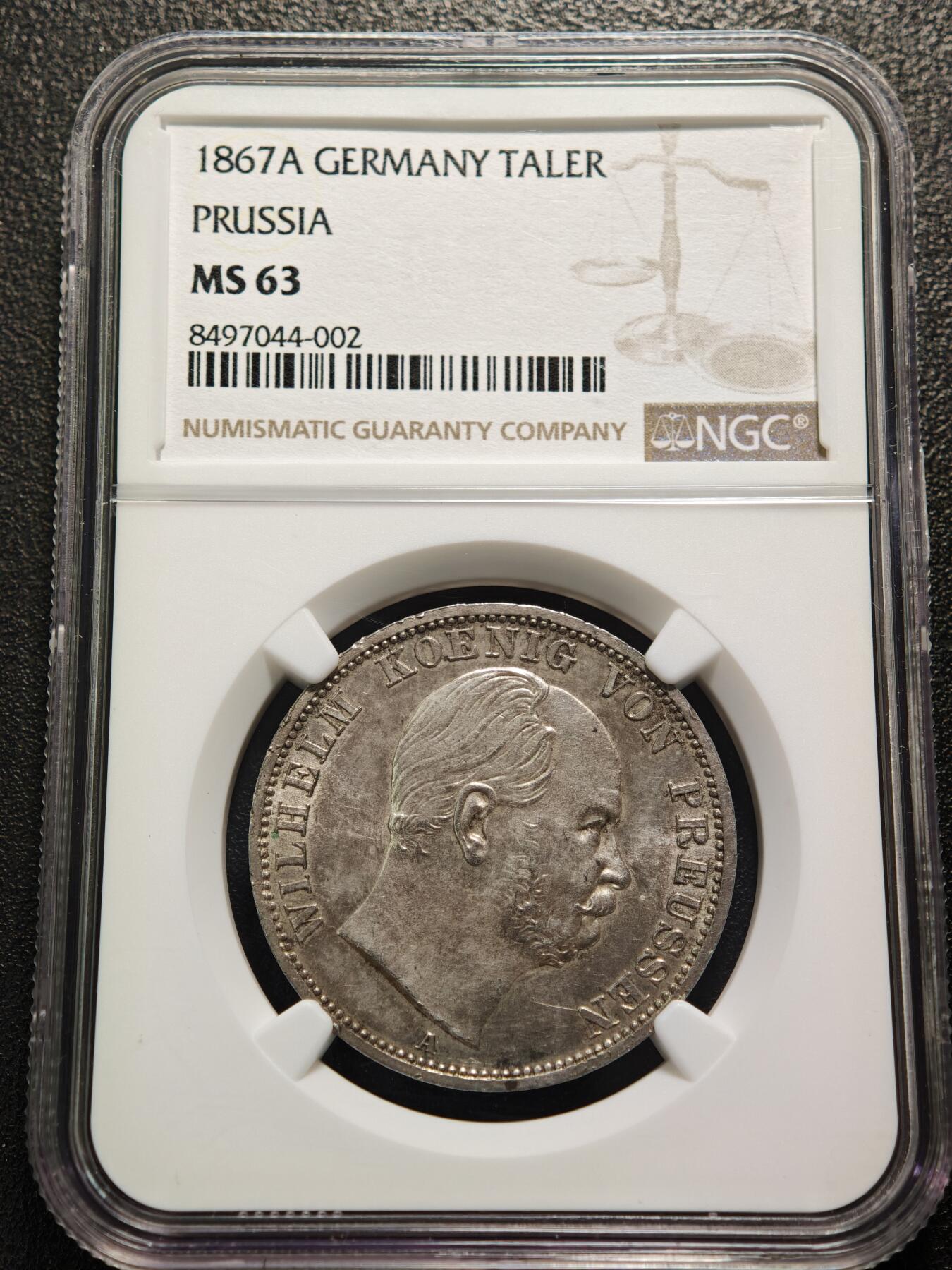 【德藏】世界币章拍卖第159期(元旦专场拍卖) 1867年 德国普鲁士威廉一世泰勒银币 NGC MS63 原味淡包浆不失原光 这枚属于德意志关税同盟泰勒体系，1857年德意志关税同盟确定该银币为统一流通货币，含银量为16.66克（900银），“XXX EIN PFUND FEIN”表示30枚该银币含1磅纯银“VEREINSTHALER”即“联合泰勒”1867年正值北德意志邦联成立这枚是普鲁士主导德意志统一进程中的流通货币,兼具经济与历史象征意义