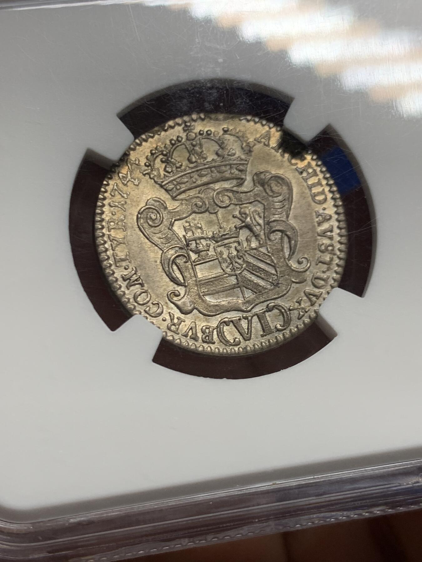 《竞宝斋》第452场 周日，周一 2场连拍 （全场包邮，欢迎送拍） NGC MS61 玛丽亚特蕾莎年轻版1744年6克鲁泽银币 大奶妈刚继承奥地利但还不是皇后的版 奥地利王位继承战争期间 所以没有帝国双头鹰只有自家领地盾(波希米亚匈牙利奥地利勃艮第) 半机制币难得的MS! 奥地利蒂罗尔的哈尔厂生产(中心盾是鹰) 滚筒造币机细节盾徽清清楚楚的压印 完整漂亮的原光淡黄包浆