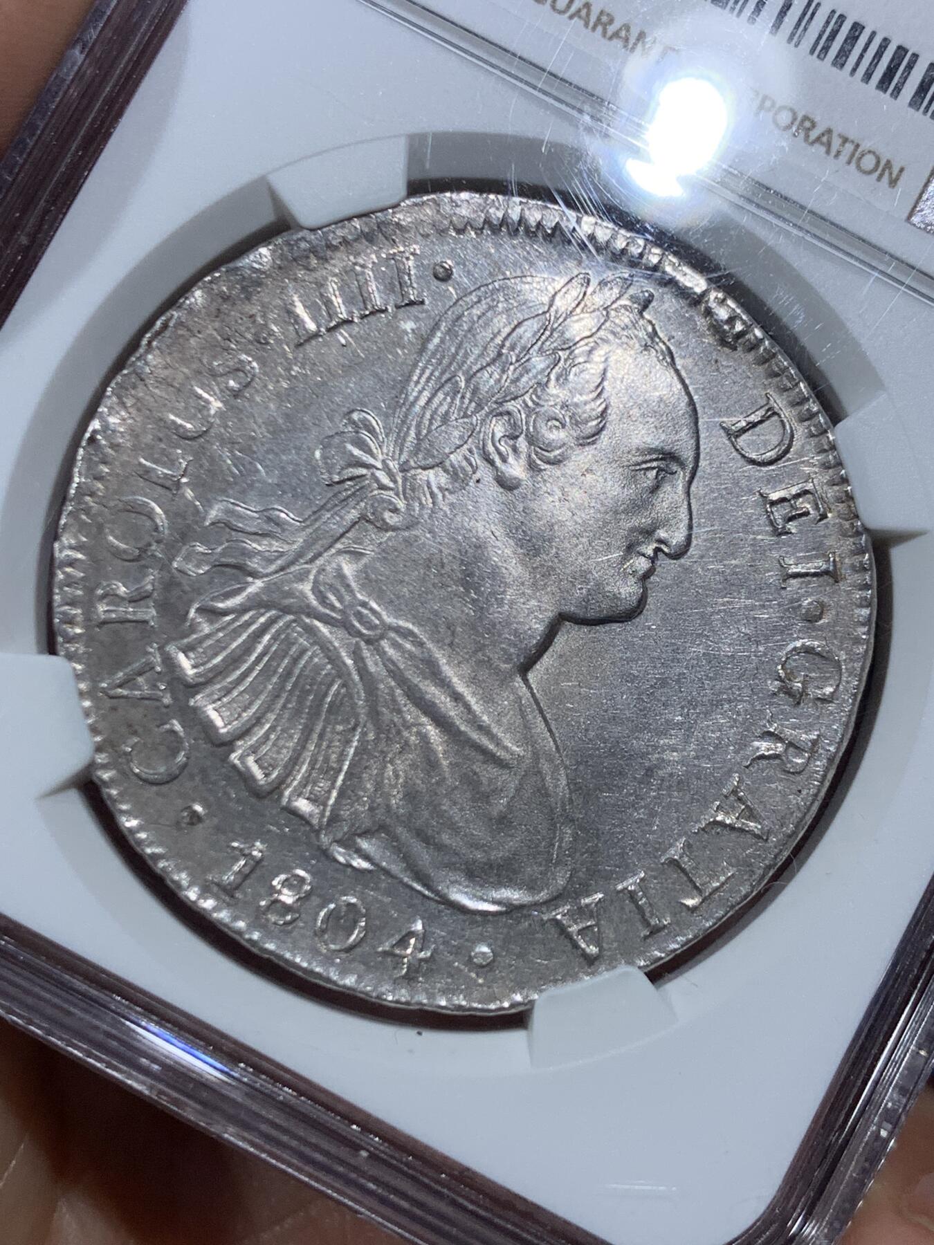 《竞宝斋》第452场 周日，周一 2场连拍 （全场包邮，欢迎送拍） NGC MS62 西属墨西哥1804年卡洛斯四世8里亚尔银币，人像状态非常好，底板略带PL质感。