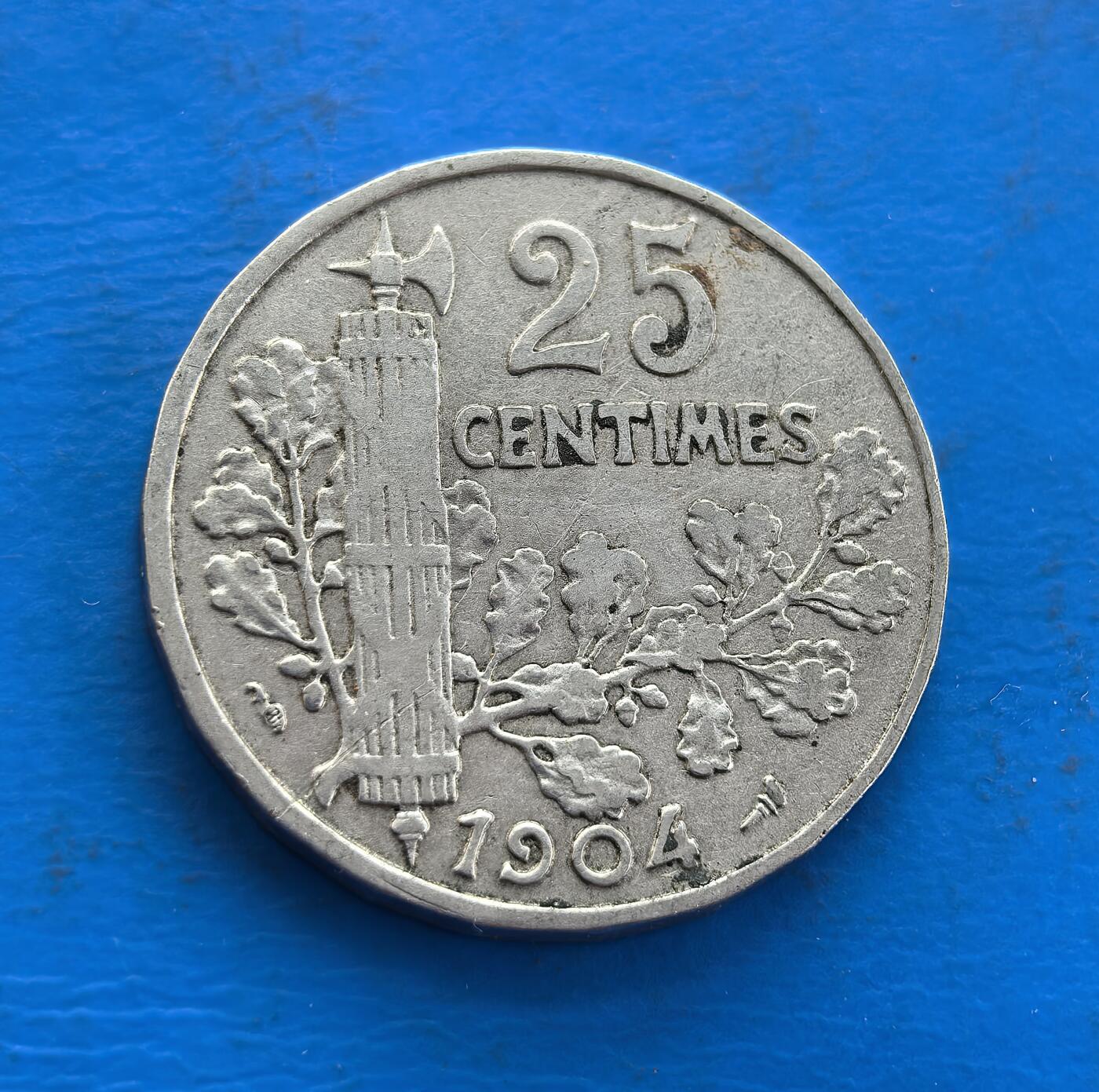 外国优质老铜币高银银币，周六九点倒数截拍，满百包邮，持续收拍 法国1904 年 25 分，属第三共和国时期。正面玛丽安娜凝萃共和精神，背面束棒（古罗马权威象征）配橡树枝，诠释自由与秩序。镍质包浆载百年痕迹，设计融合古典符号与法兰西理念，是解码欧洲共和文化、收藏思想载体的独特标的，历史厚重与象征意趣兼具 。