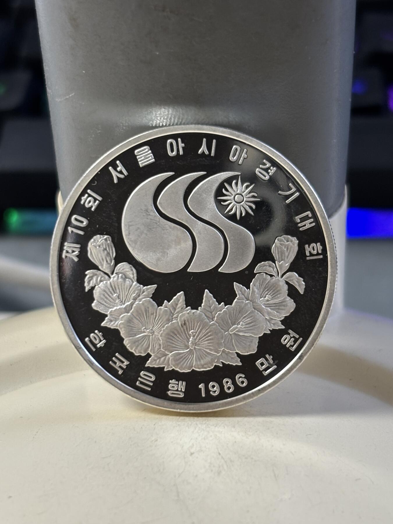 第186期拍卖 韩国1986年第十届亚洲运动会羽毛球纪念银币，900银，23克银价373，有瑕疵，没有塑料盒