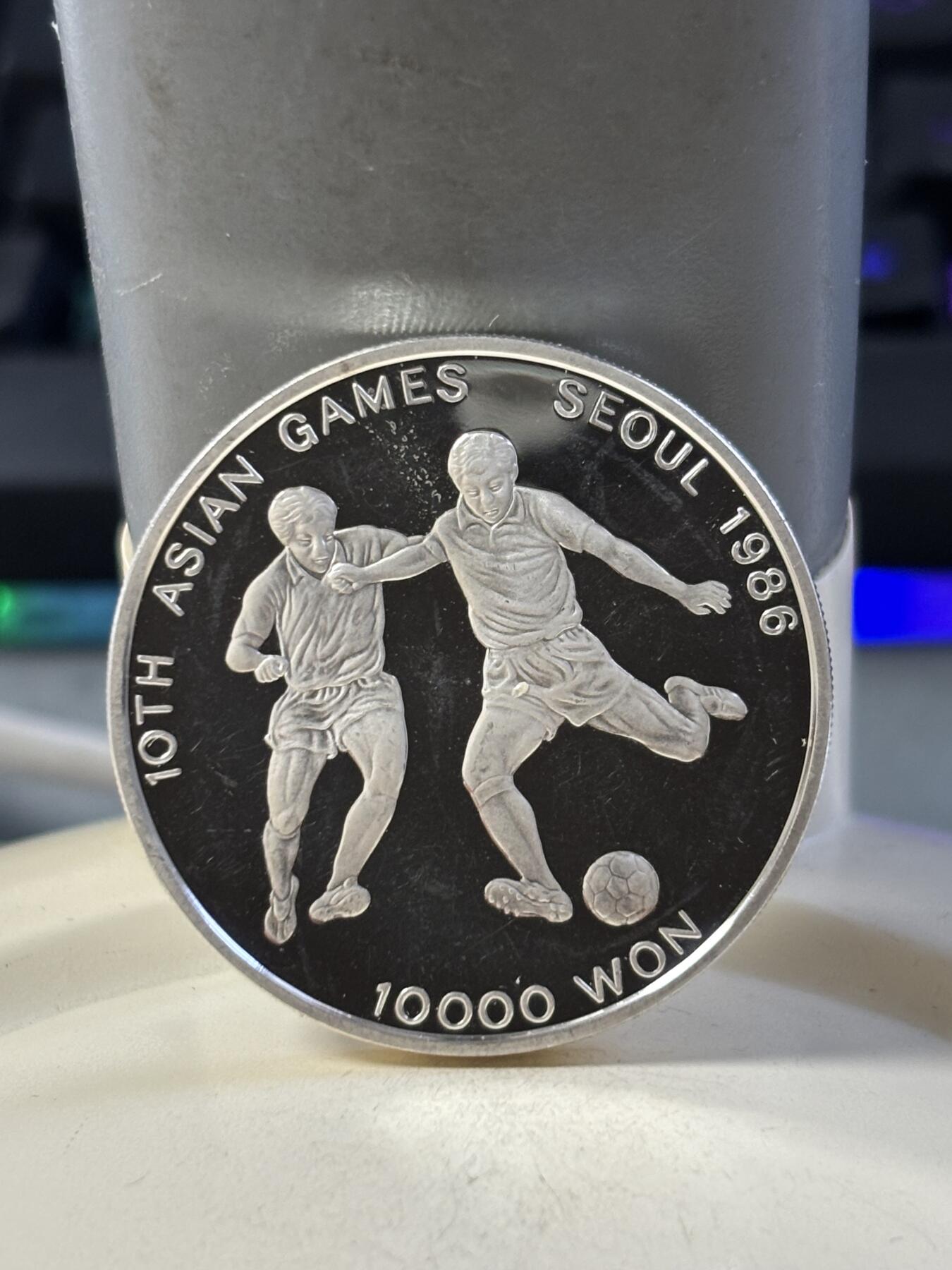 第186期拍卖 韩国1986年第十届亚洲运动会足球纪念银币，900银，23克银价373，有瑕疵，没有塑料盒