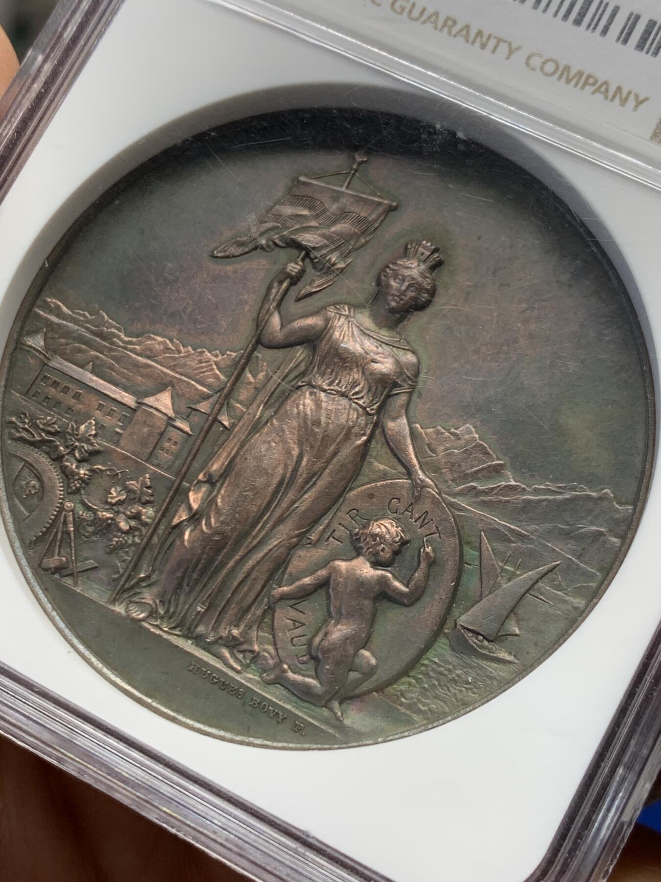 《竞宝斋》第454场 周日，周一 2场连拍 （全场包邮，欢迎送拍） NGC UNC 瑞士1891沃州射击节铜章 巧克力色 人物生动 细节保存非常好 加厚盒装