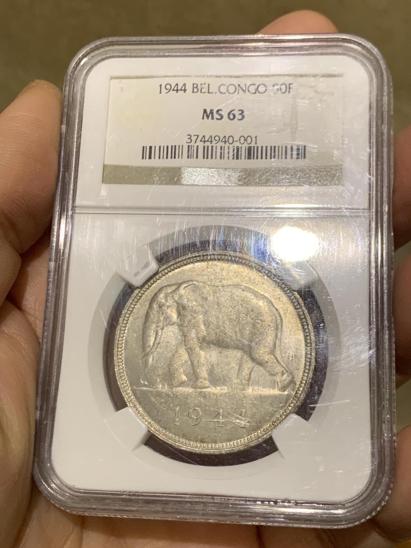 《竞宝斋》第454场 周日，周一 2场连拍 （全场包邮，欢迎送拍） NGC MS63 比属刚果1944年大象50法郎大银币，非洲名誉品，同分书价500美金。淡彩好状态，NGC老盒保障。殖民地经典主币，非洲象威武雄壮