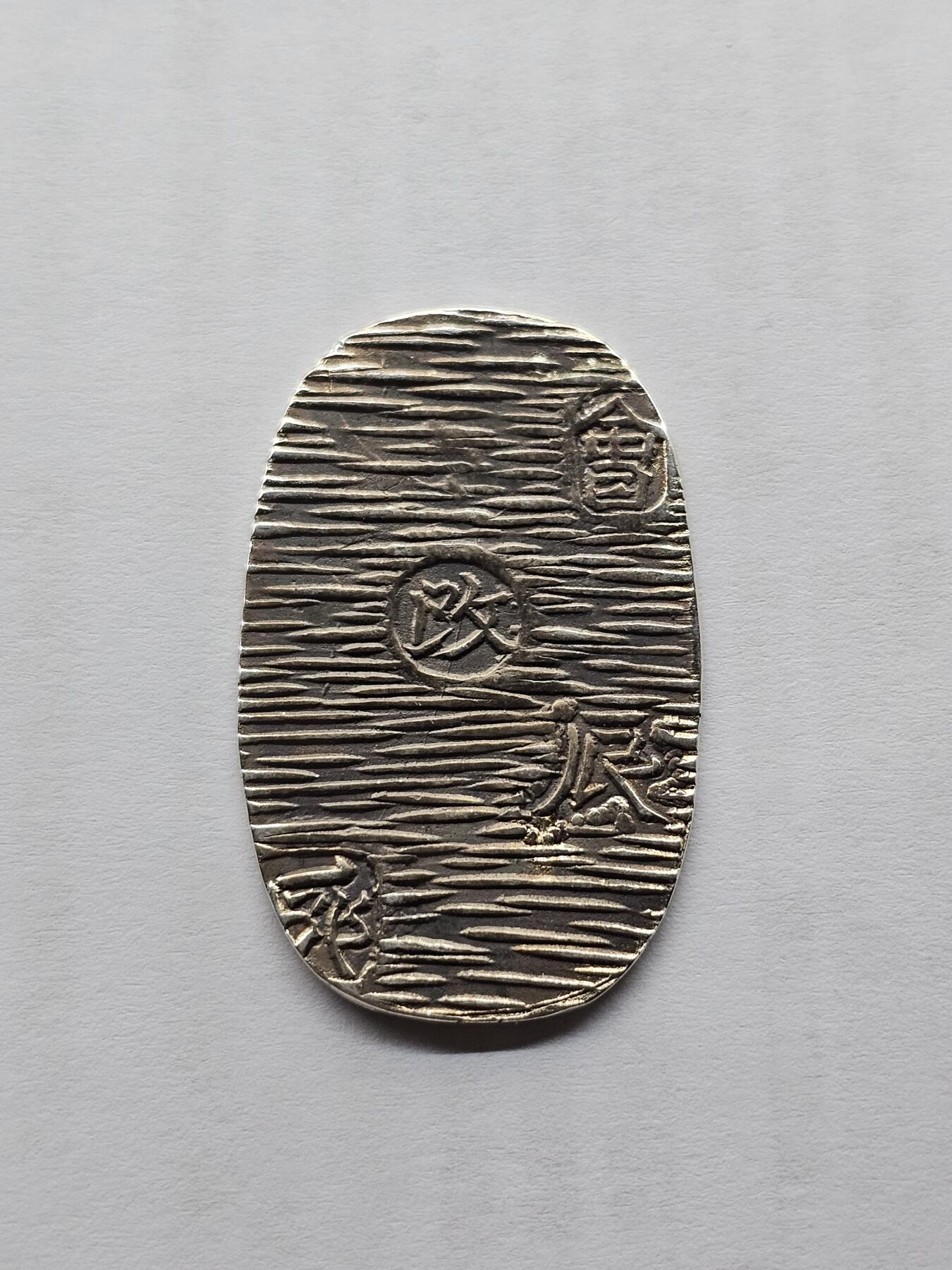 日本回流银判，椭圆形，正面有花纹和“二分”字样，背面有“政”字样，银质，非流通外国钱币，品相以图为准，成色还可以，适合收藏或摆件。