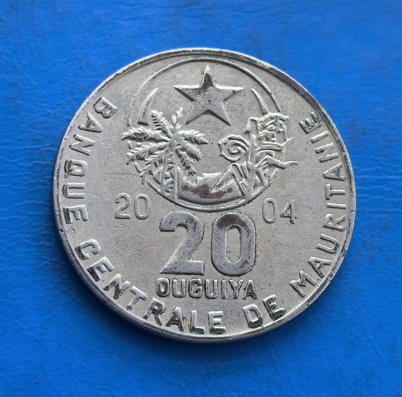 外国优质银币非洲美洲币，周六九点倒数截拍，满百包邮，持续收拍 毛里塔尼亚 20 乌吉亚，正面展星月、棕榈等本土元素，背面饰麦穗与阿拉伯文，风格融合西非伊斯兰文化，是毛里塔尼亚现代流通币，具地域货币收藏价值。