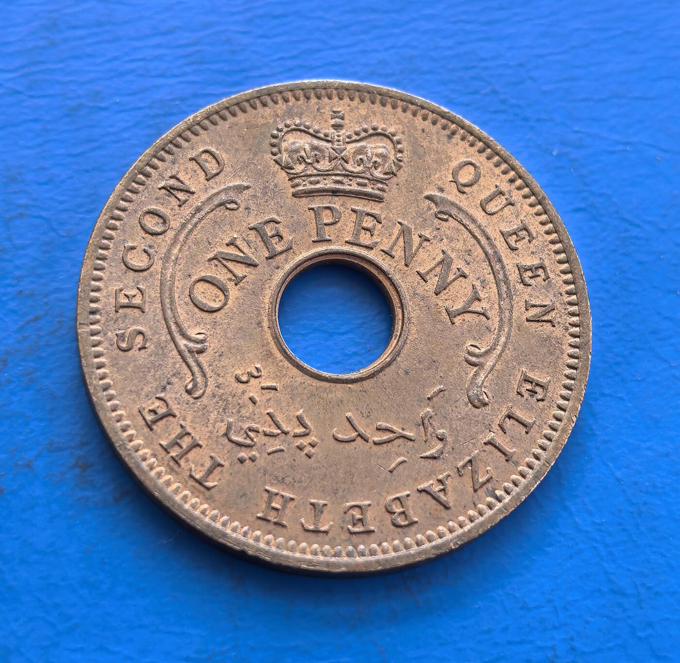 外国优质银币非洲美洲币，周六九点倒数截拍，满百包邮，持续收拍 尼日利亚联邦1959 年 1 便士硬币，带圆孔 + 六角星设计，标英联邦王室标识，属尼日利亚独立前英属货币，风格具殖民联邦特征，是西非英殖币收藏品类。