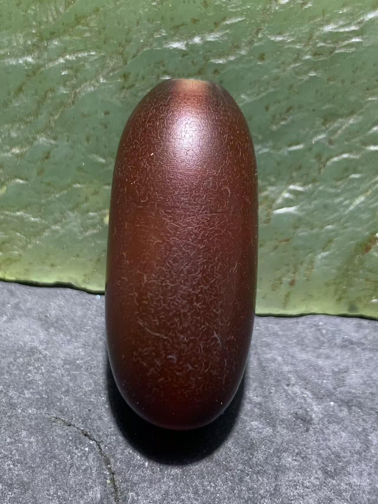 高玉化酒红色玛瑙瑕疵随形桶珠一颗，