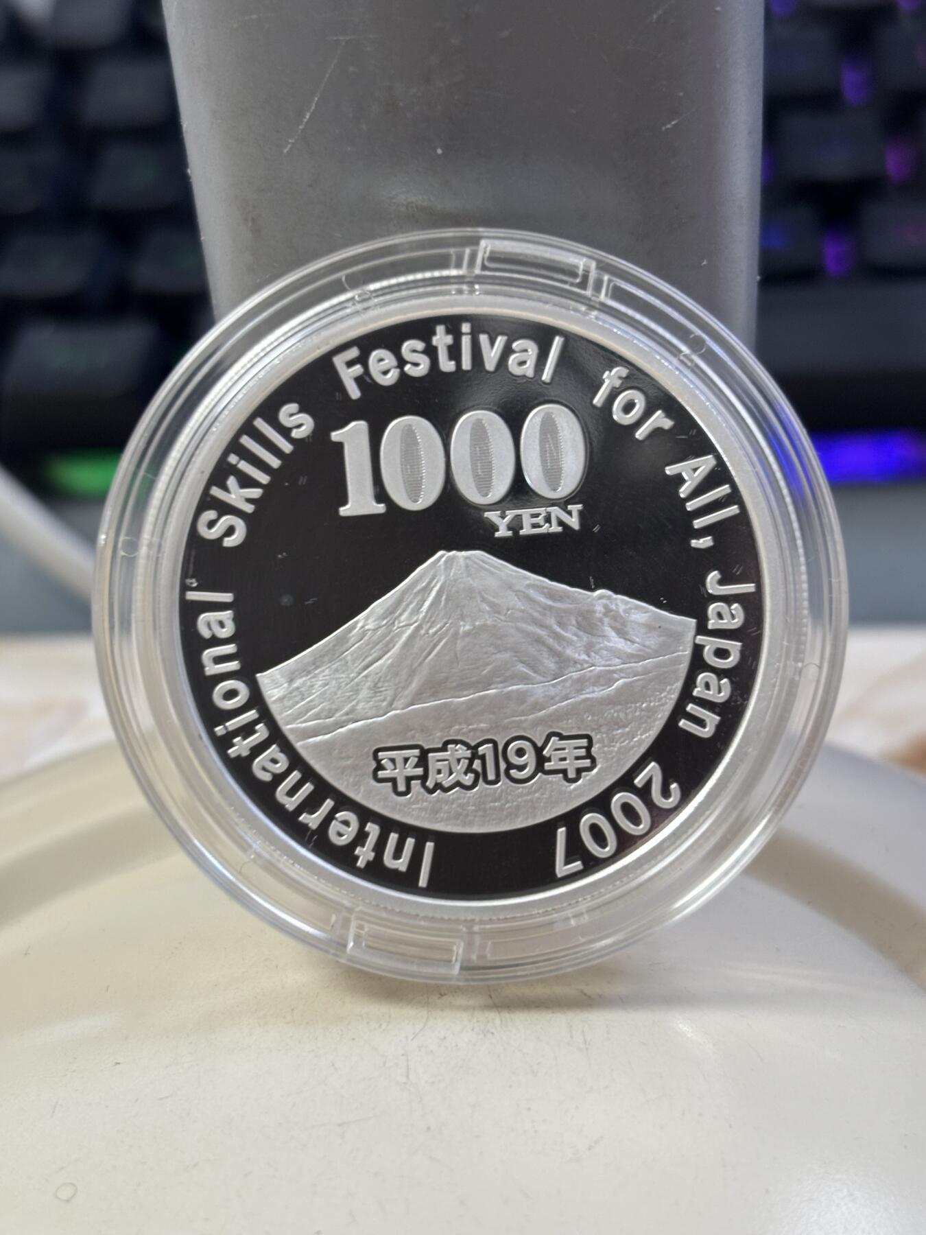 第187期拍卖 日本2007年1千日元精制彩色银币 国际技能节 31.1克 999银，银价373，发行量：8万枚