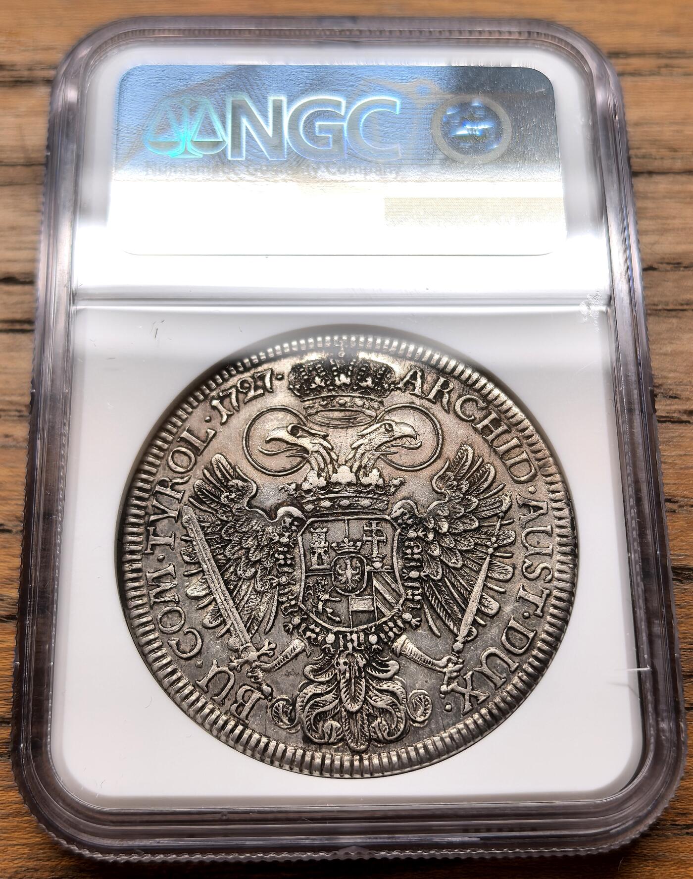 凡希社世界钱币微拍第三百十八期 荐！1727神罗哈布斯堡王朝卡尔六世戎装像泰勒大银NGC-MS61，铁灰色包浆，注意正面的卷发和月桂冠细节。1727年正值卡尔六世推动《国本诏书》确立哈布斯堡家族继承规则的关键时期，此币是神圣罗马帝国中期货币体系的重要实物，布雷斯劳铸币厂版本少于维也纳铸币厂版本，它直观地反映了帝国东部领地的铸币权分布。（视频参考）