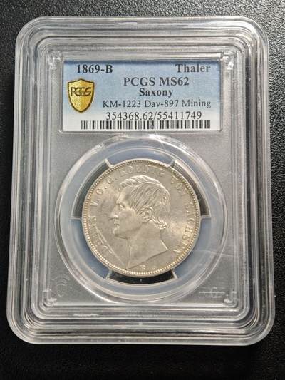 【德藏】世界币章拍卖第161期 -  1869年 德国萨克森约翰一世矿业祝福泰勒银币 PCGS MS62 淡黄油包浆 转光十足 萨克森是19世纪德国重要的矿业与冶金中心，银、锡、铁等矿产资源的开采与加工是其经济支柱，约翰一世时期发行此币，既是对矿业产业的致敬，也彰显了萨克森的经济特色