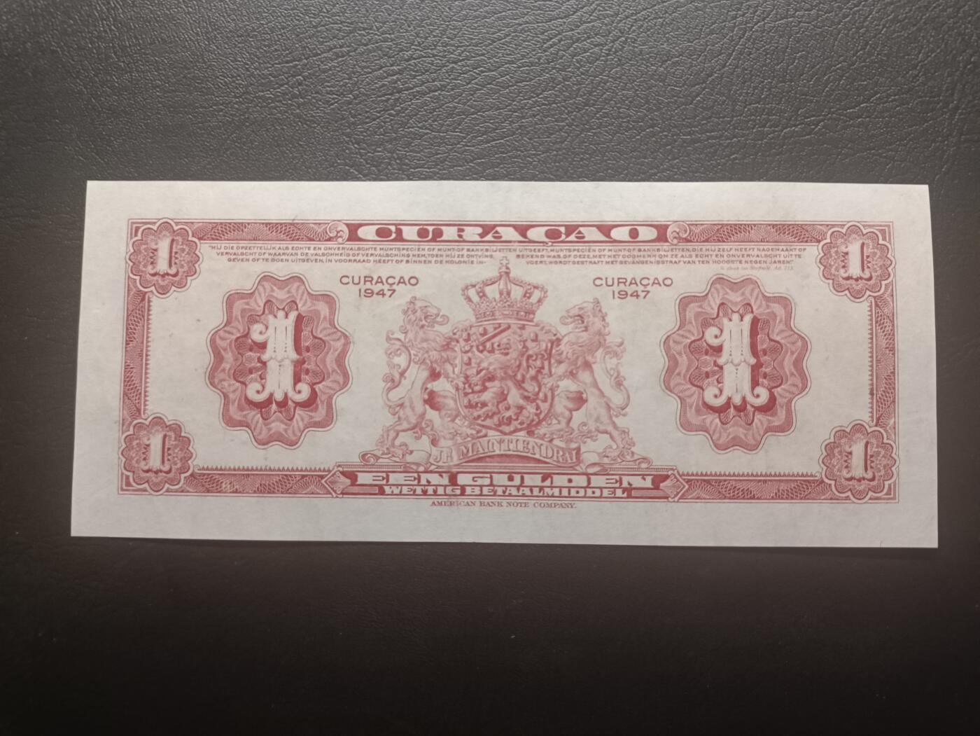 2026一月第三期，总213期 荷属库拉索1947年1盾AUNC无47，轮船环绕的商业神墨丘利和总督府徽章，稀有荷属领地品种