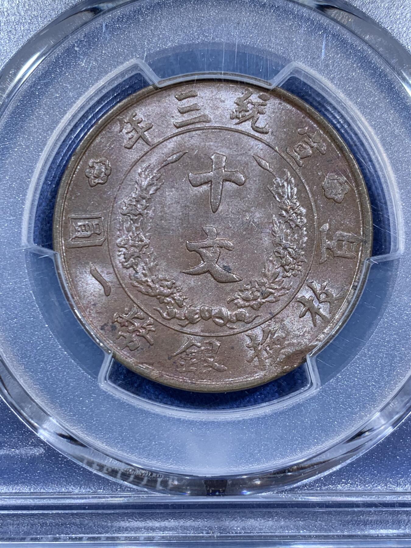 《竞宝斋》第460场 周日，周一，2场连拍 （全场包邮）欢迎送拍 PCGS MS62BN 宣统三年(1911)大清铜币十文，清代铜元代表作，见证辛亥荣光和大清落幕。龙鳞粒粒，巧克力底板。背面边缘币胚缺陷，可加钱申请Mint Error。高峰时宣和春拍同分7500元不含佣成交，如今入手好时机