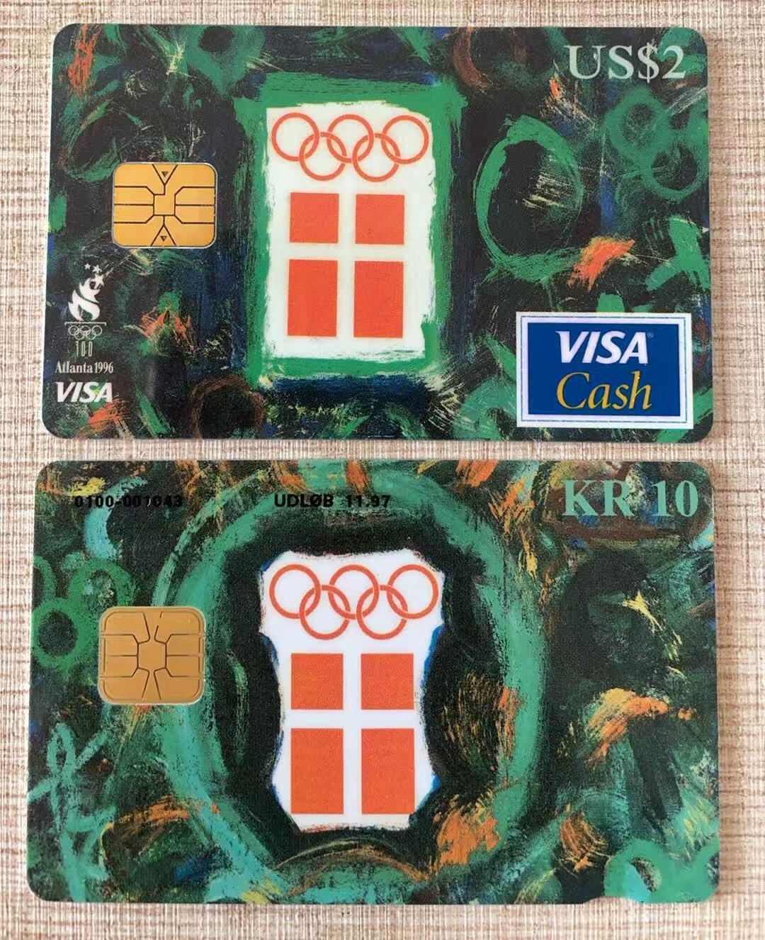 《卡拍》第343期拍卖1月24日晚22：10时延时截拍 美国丹麦联合发行VISA Cash现金IC卡《96亚特兰大奥运会-丹麦奥委会旗，背有可口可乐标志》两枚未使用新卡（同流水号1043），上品。发行量2000套。