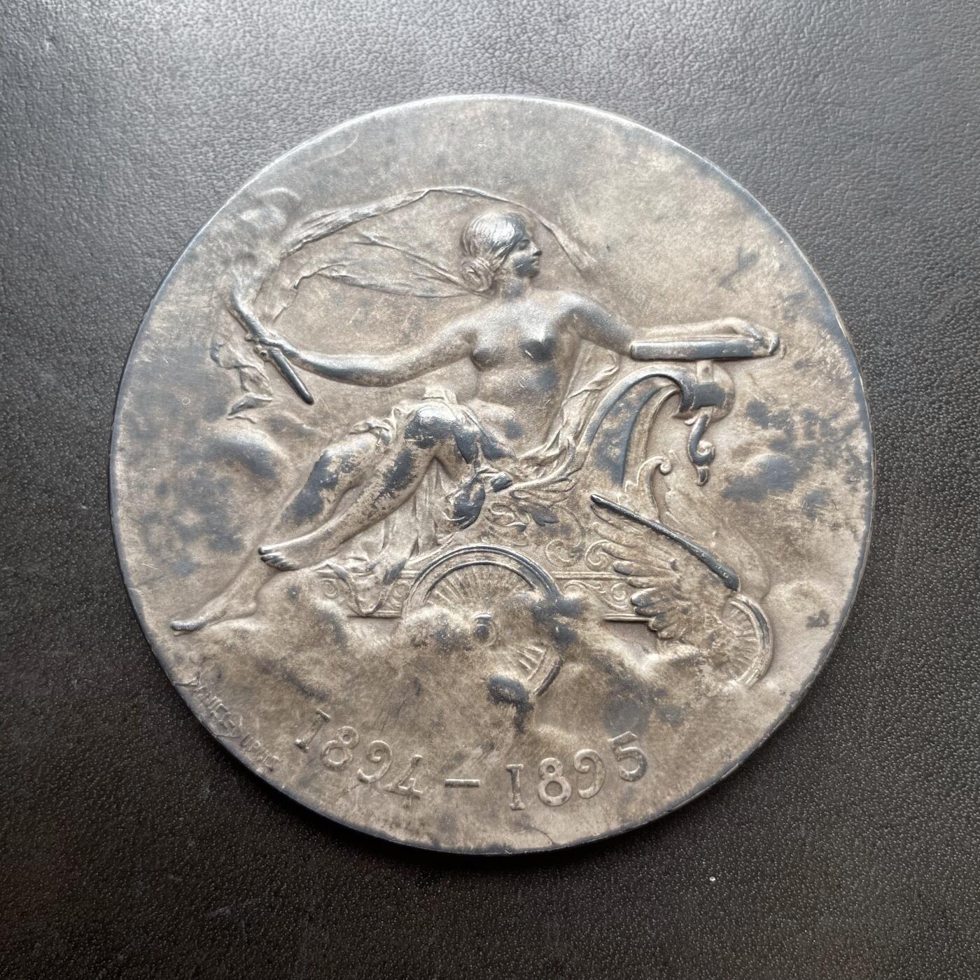 「木头集藏」章牌精品专场！ Daniel Dupuis～1902年法国汽车俱乐部云霄飞车大银章 ，直径：68mm，138g，边铭：丰饶角 ARGENT。经典的清凉美女章，实物品相不错，只是正面包浆不太均匀。根据背面铭文，此章是法国汽车俱乐部在1902年组织的一次剑术精英赛中授予拉博德伯爵的。1902年2月28日的《投石党报》刊文记载了这一盛事：“拉博德伯爵挥舞着剑，赢得了热烈的掌声”。  