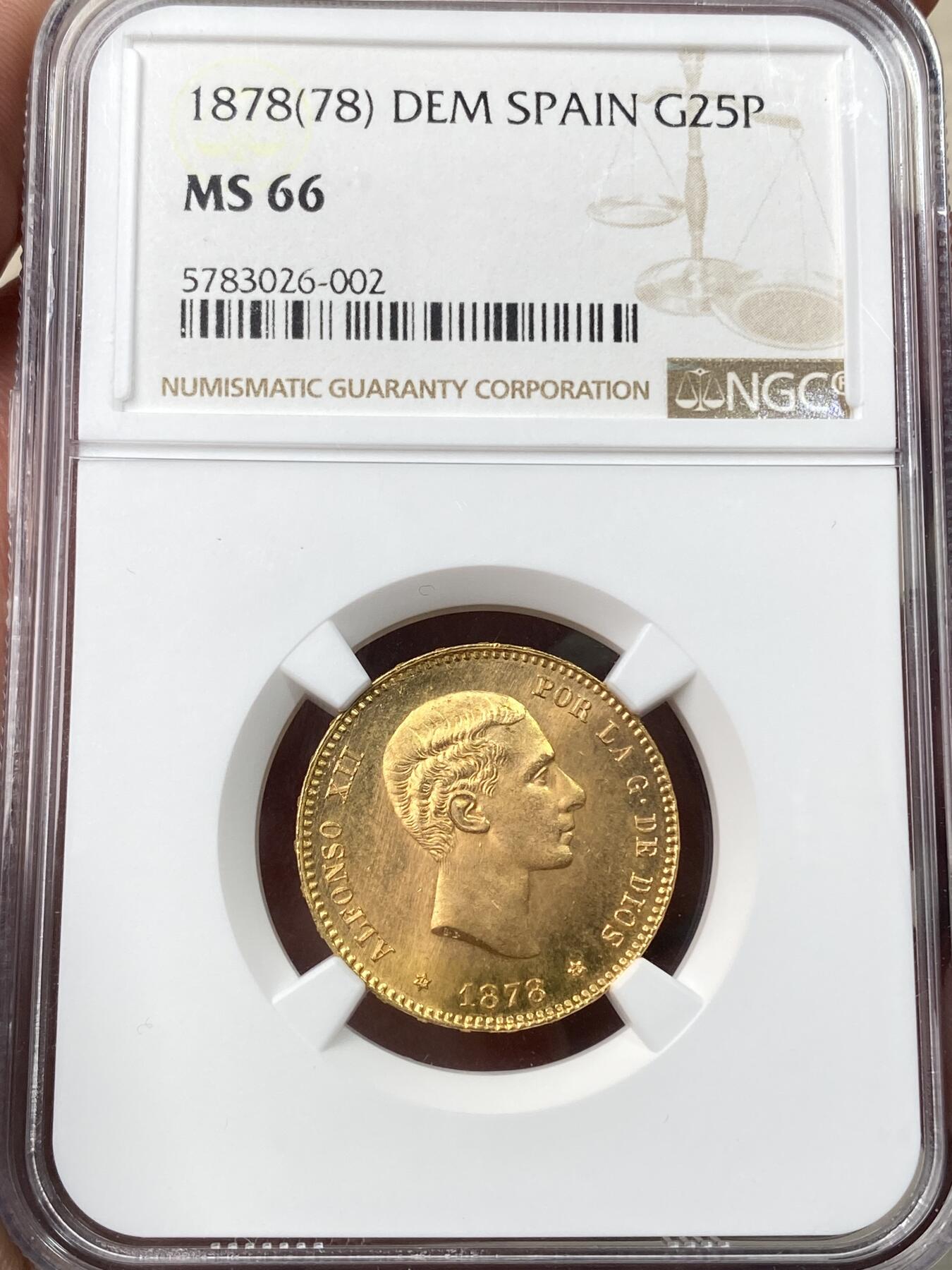 万国钱币拍卖第059期 NGC MS66 1878西班牙阿方索十二世25比塞塔金币 大量进入流通的西班牙金币品种 GEM级别可谓难得一见 丝绸金光类镜面质感 肉眼无暇状态 堪称完美的顶级典藏品质 8.06g 900金