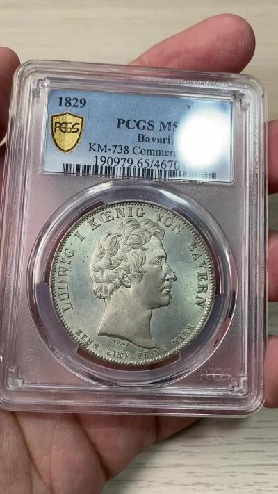 万国钱币拍卖第059期 PCGS MS65 1829年德国巴伐利亚路德维希一世贸易协定历史泰勒  纪念巴伐利亚、普鲁士、符腾堡和黑森之间的贸易协定泰勒 极其难得的BU级别历史大泰勒 银光在币面如流水般泻出  喷砂质感的四邦纹章紧密围绕在象征繁荣富裕的丰饶角周围 实物上手惊艳