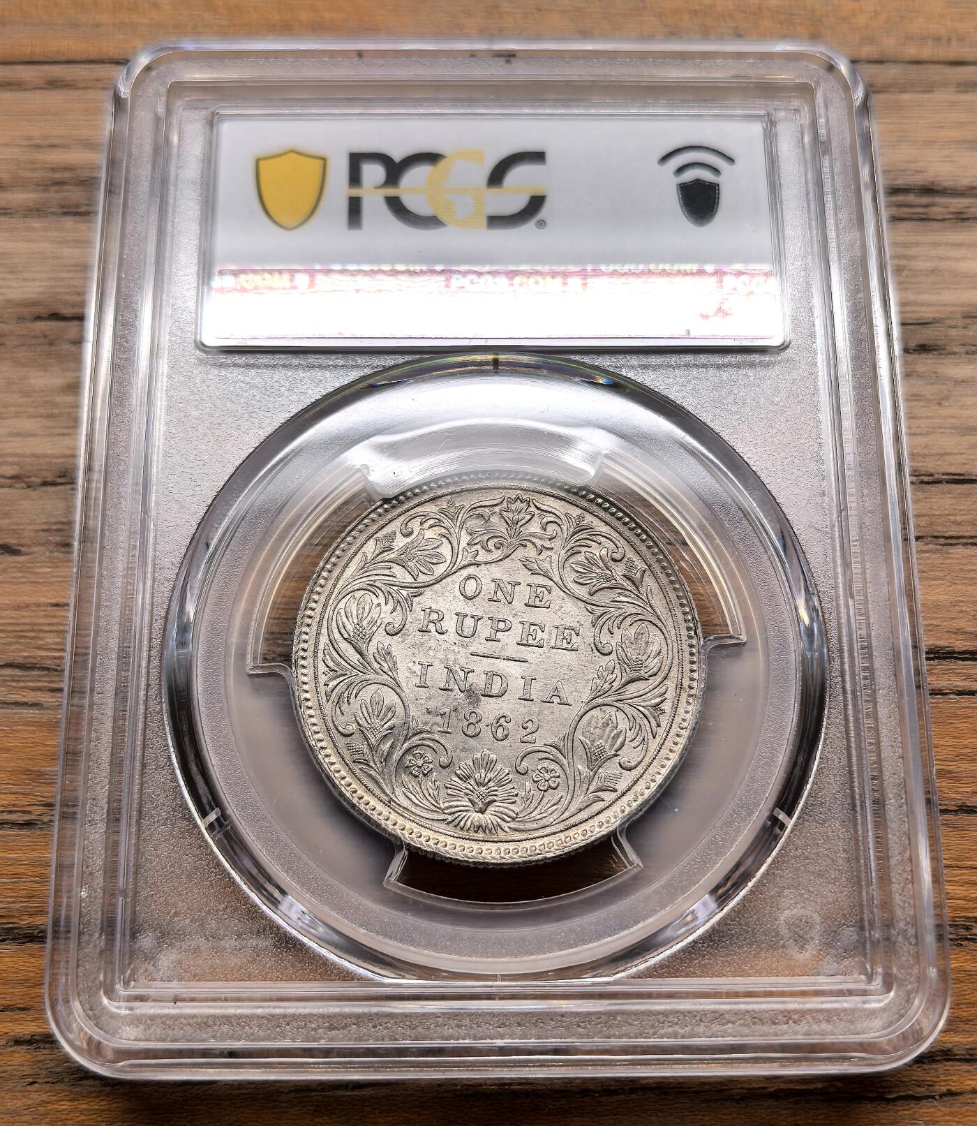 凡希社世界钱币微拍第三百十九期 1862英属印度小维像卢比银币PCGS-MS63，淡彩香槟金包浆，马德拉斯厂出品，较稀有的厂版。