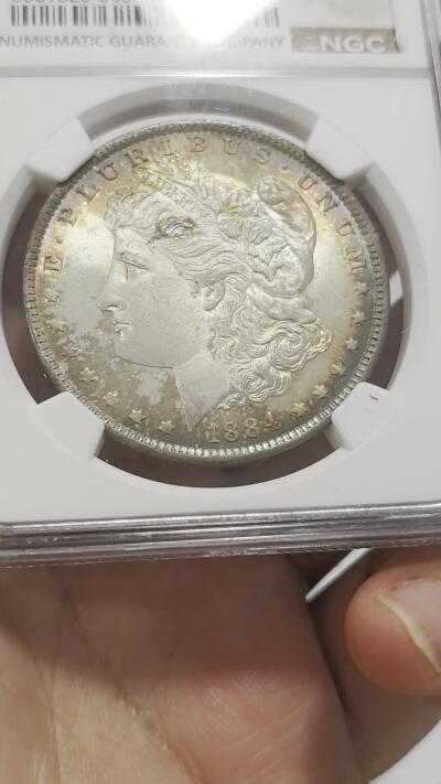 博洋堂世界钱币拍卖第158期（全场包邮） NGC MS65 美国1884年O版摩根大银币，正面环彩，背面金色包浆，状态出众