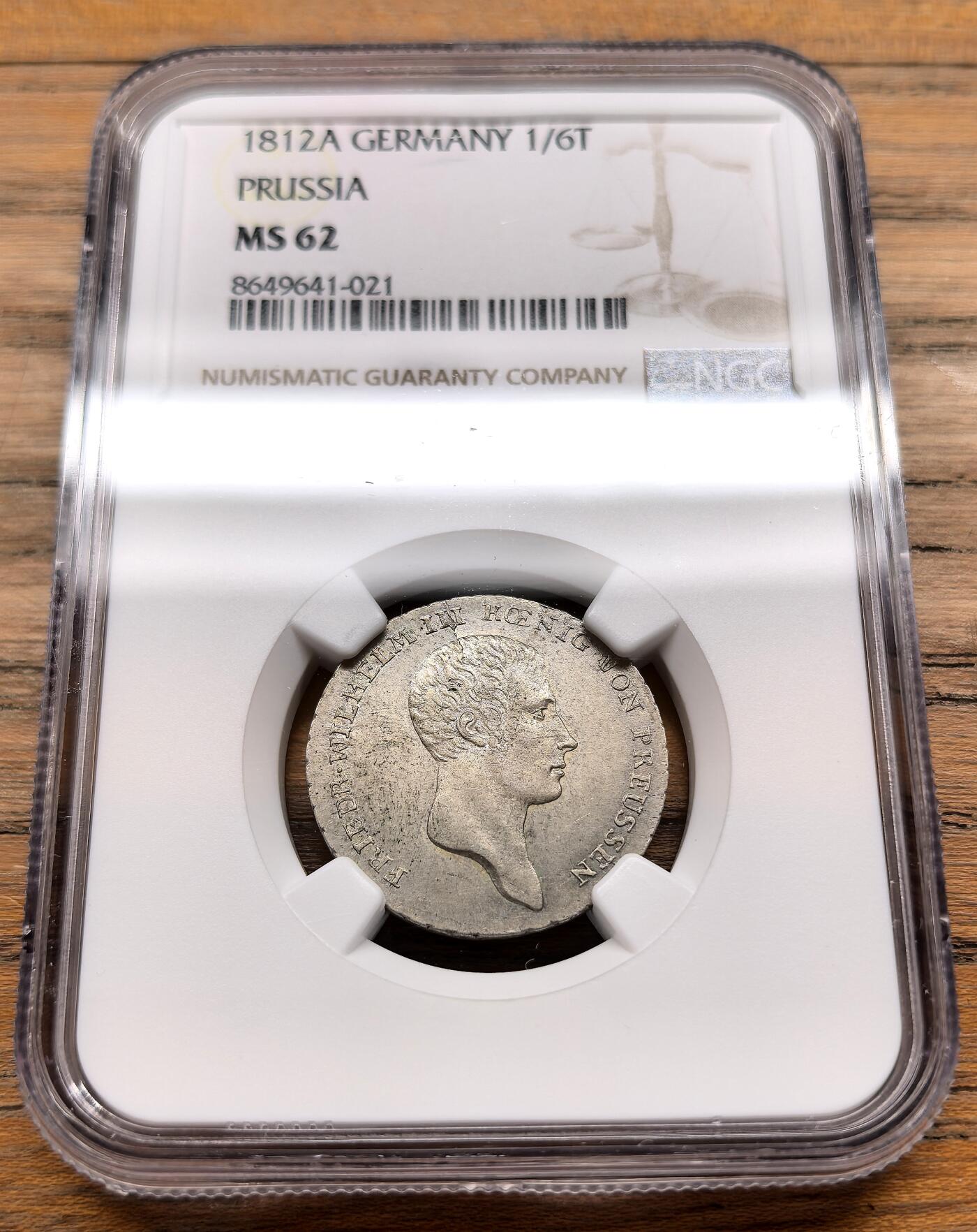 凡希社世界钱币微拍第三百十九期 1812A德国普鲁士王国威廉三世1/6泰勒NGC-MS62，1812年正值拿破仑战争的关键时期，普鲁士作为反法同盟成员，发行此币以支撑战时经济与流通需求，此枚通体欧陆灰彩，压铸细节深峻，光泽优美。