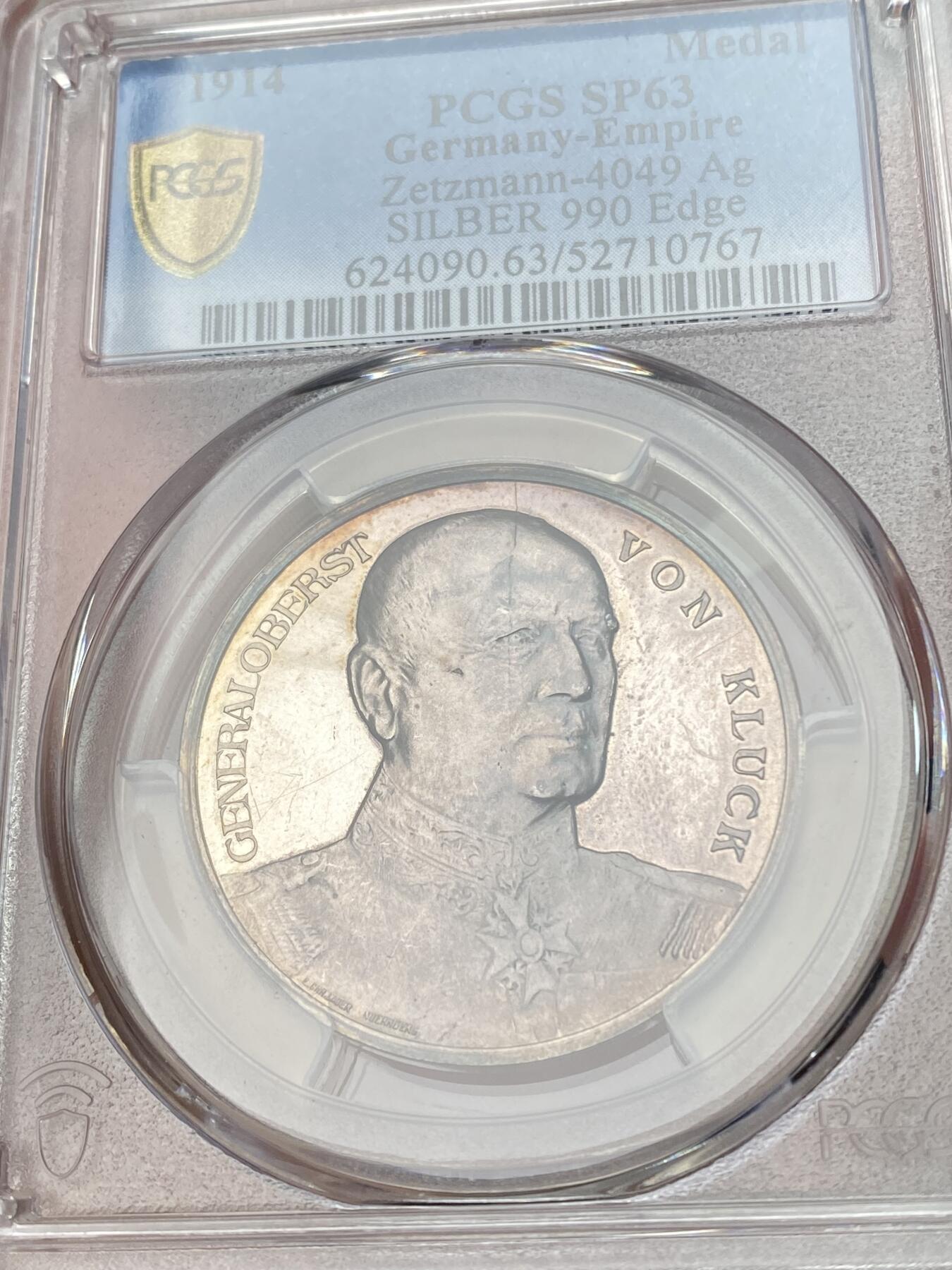 万国钱币拍卖第059期 PCGS SP63 1914年德国一战期间亚历山大·冯·克鲁克将军纪念银章 纽伦堡造币厂铸  双面极强的镜面喷砂质感 990超高银版；反面文字意为：献给胜利的陆军统帅 克鲁克将军是德国普鲁士军官，陆军上校将军，第一次世界大战爆发后，他被任命为德军第1集团军司令，赢得了蒙斯和勒卡托等战役的胜利
