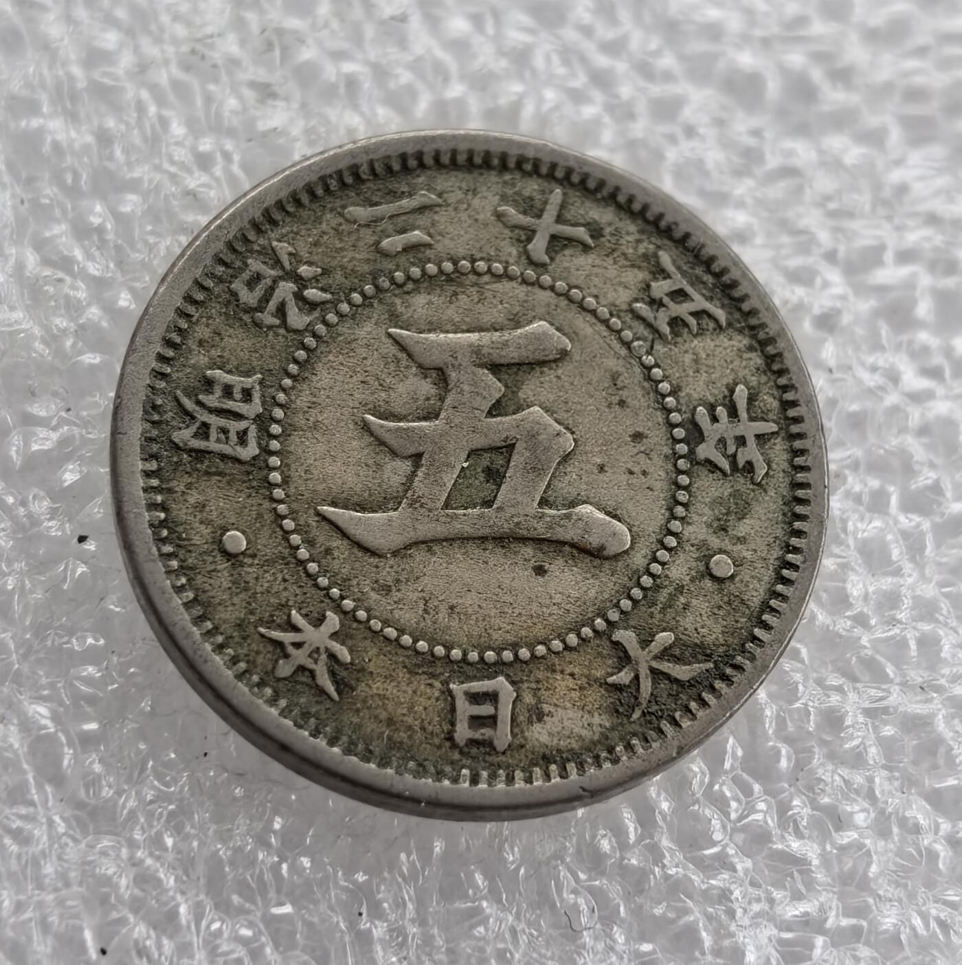 外国优质老铜币高银银币，周六九点倒数截拍，满百包邮，持续收拍 明治二十五年日本五钱，正面中央 “五” 字醒目，环书 “大日本明治二十五年”，字体古朴；背面饰十六瓣八重表菊纹（皇室徽），旁铸 “五钱” 与 “5 SEN”，中西合璧。包浆自然，兼具日本近代货币史与皇室文化收藏价值。