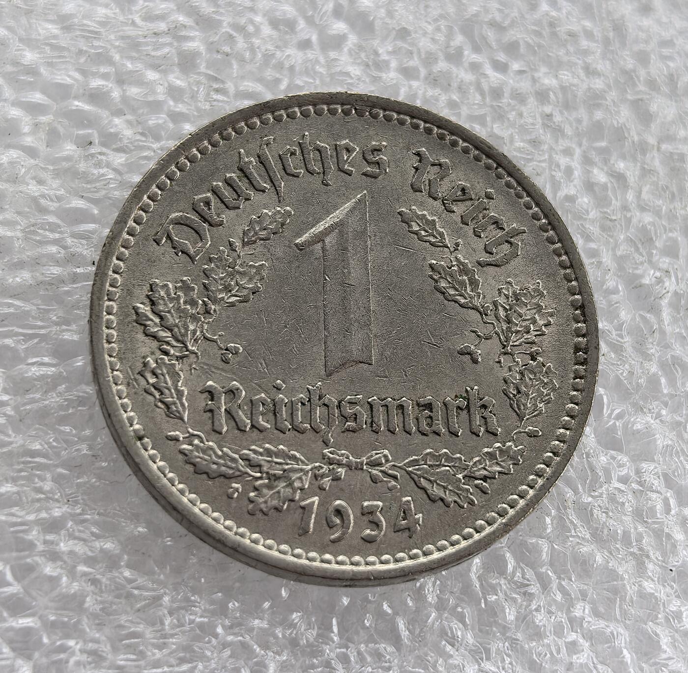 外国优质老铜币高银银币，周六九点倒数截拍，满百包邮，持续收拍 德国1934年1马克A版，正面铸纳粹帝国鹰与 “公共利益先于个人利益” 铭文，A 版柏林造币厂；背面为 “德意志帝国”、面值及橡树叶。属纳粹德国初期，是希特勒上台后，纳粹意识形态与货币结合的实物见证