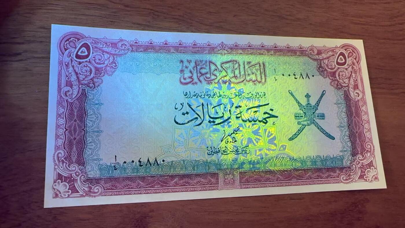 徐霞客拍卖首拍 阿曼	P-18a 1977年5里亚尔 A/4 004880	unc-	阿曼苏丹国5里亚尔纸币 正面以阿拉伯书法标注面额，配阿曼国徽核心双剑纹章，彰显王室权威与伊斯兰属性。 发行于阿曼现代化建设初期，见证该国从传统经济向油气经济转型。 背面为清真寺图案，呼应伊斯兰宗教核心地位。 币面融合阿拉伯书法艺术与伊斯兰纹样设计，采用红、蓝、金三色套印工艺。		