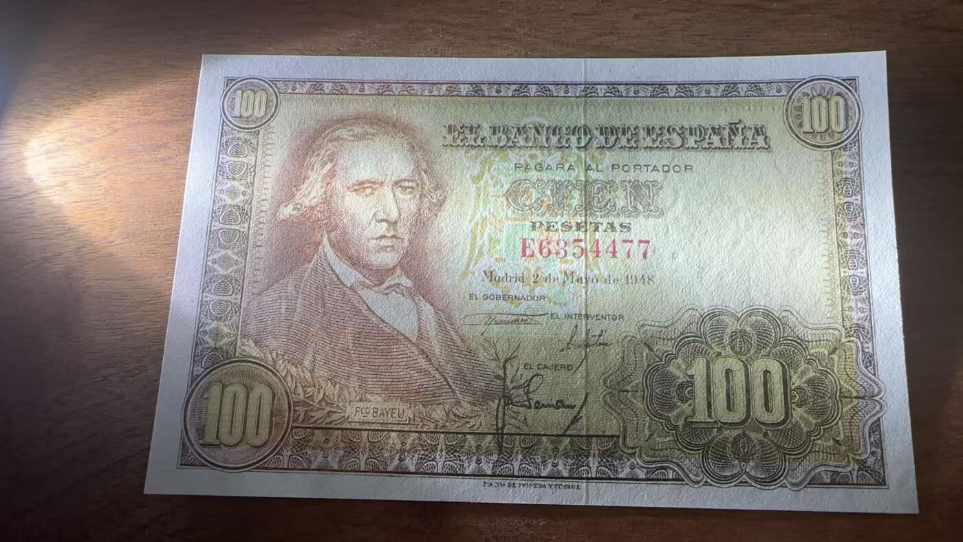 徐霞客拍卖首拍 西班牙	P-137 1948年100比塞塔	E6354477	unc-	这张纸币于1948年5月2日在马德里发行，正面主像为西班牙浪漫主义画家弗朗西斯科·巴耶乌，通过采用棕黄渐变套印与精细雕刻凹印工艺，花纹繁复且防伪性强，作为战后西班牙发行的首批大面额纸币之一，存世量已极为稀少，在欧洲纸币收藏中属于“小众精品”。		