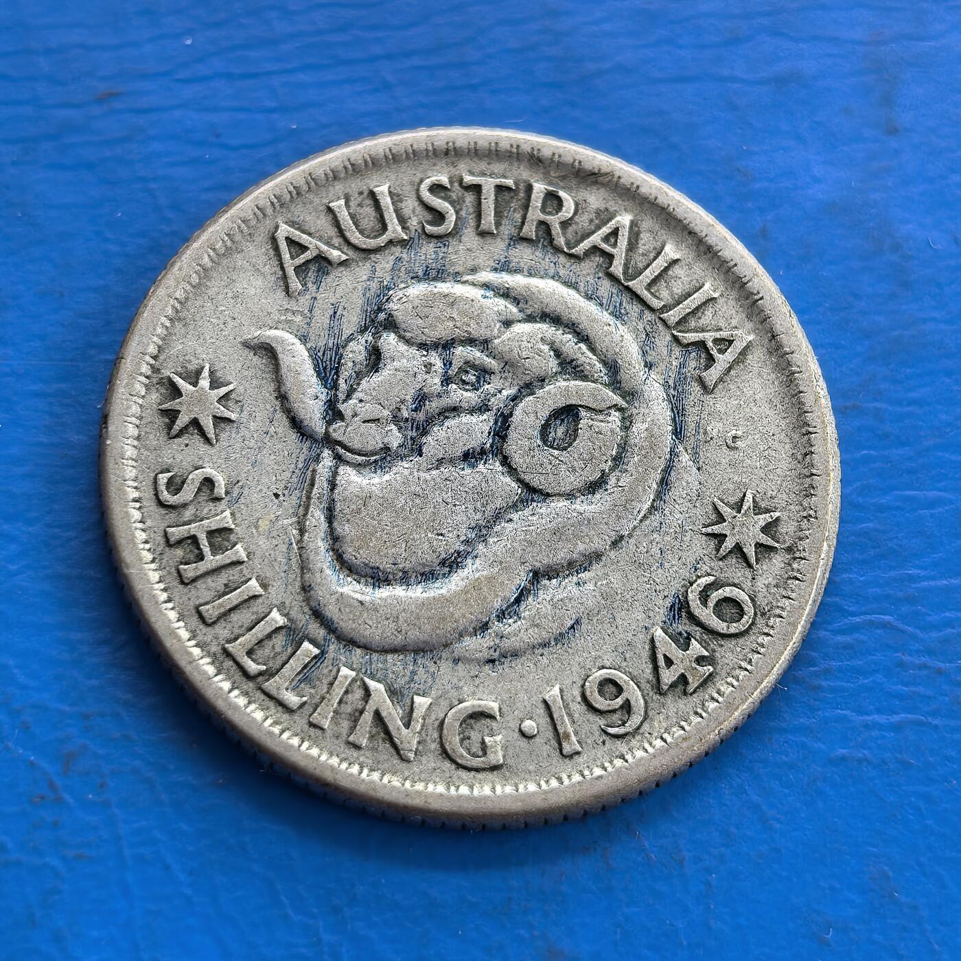 外国优质老铜币高银银币，周六九点倒数截拍，满百包邮，持续收拍 澳大利亚1946年1先令银币，正面为乔治六世国王侧面像，铭文彰显其君主身份；背面是澳洲原住民风格的蛇形图腾，搭配星纹与纪年，兼具英国殖民印记与本土文化特色，是二战后澳大利亚货币的典型代表。