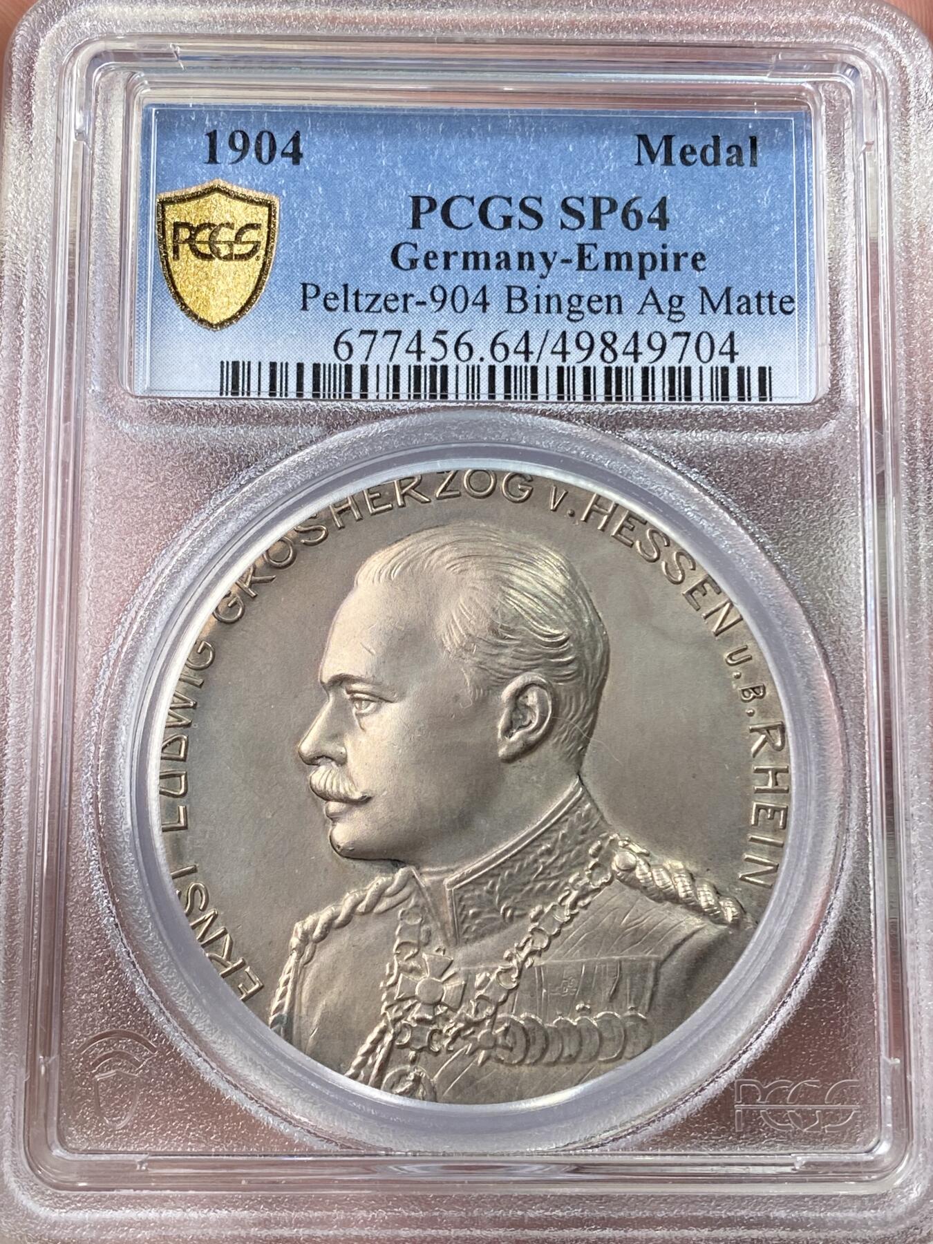 万国钱币拍卖第060期（万国六十期纪念大拍） PCGS SP64 1904年德国宾根射击节银章 少见加重版本 高浮雕精铸磨砂工艺，加厚盒。冠军分，顶级品相。城市自然景观，cityview银章。正面:莱茵河畔宾根亲王恩斯特·路德维希戎装勋章半身像。背面:莱茵河畔宾根城市景观，克洛普城堡，圣马丁大教堂，宾根鼠塔。山坡上是著名帝国纪念碑，日耳曼妮娅女神托举皇冠。为了纪念1871年德意志帝国的建立而建造。38米高的纪念碑代表了所有德意志人的联合。