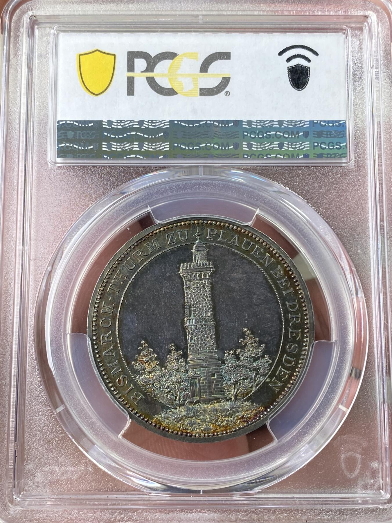 万国钱币拍卖第060期（万国六十期纪念大拍） PCGS SP64 1896年德国德累斯顿-普劳恩俾斯麦纪念塔建成纪念银章 唯一评级记录 冠军分顶级状态。极稀品种。精制工艺，浮雕镜面紫罗兰五彩，实物绝美。正面：普劳恩市华丽纹章。背面：森林中的俾斯麦纪念塔，雕刻细节极佳。俾斯麦纪念塔旨在充当火炬灯塔，塔上的火盆会在特定的日子点燃，以纪念这位铁血宰相在1871年统一德国的功绩。